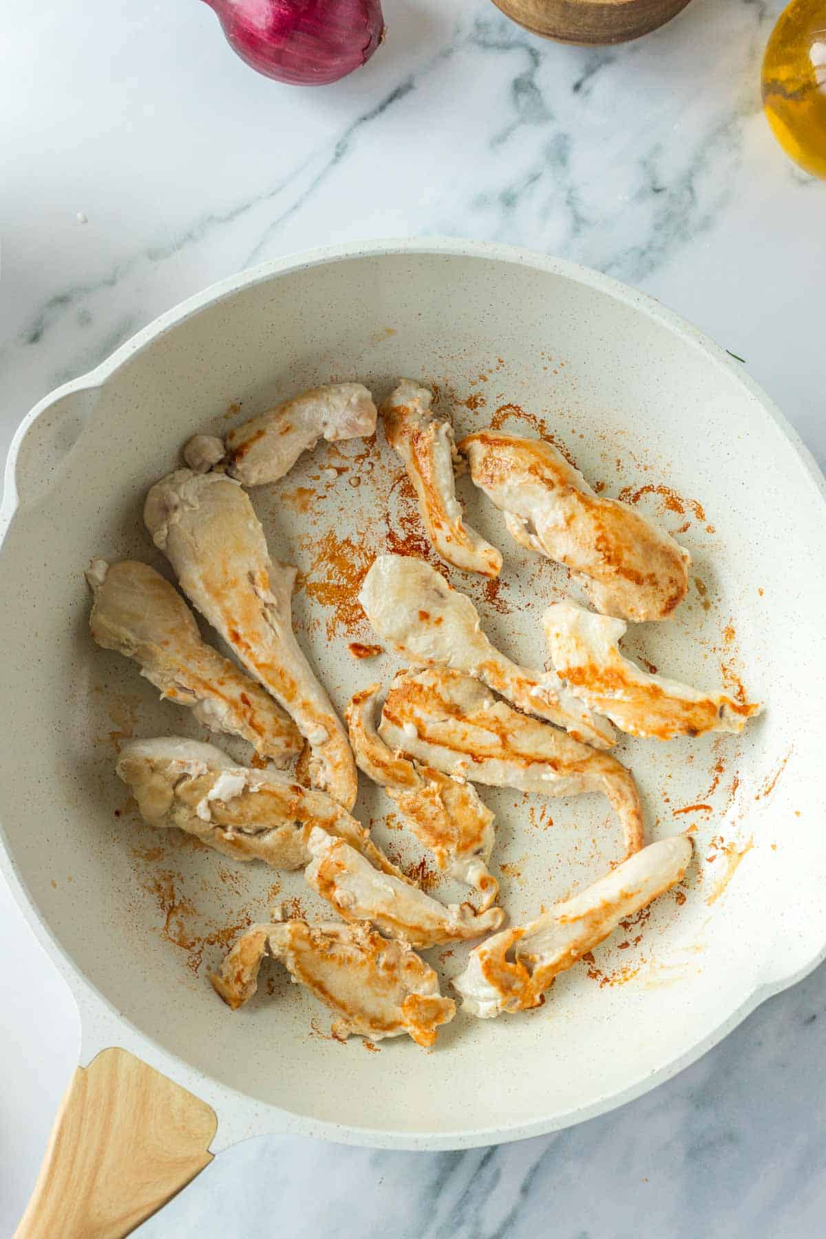 cooked chicken fillets in a skillet