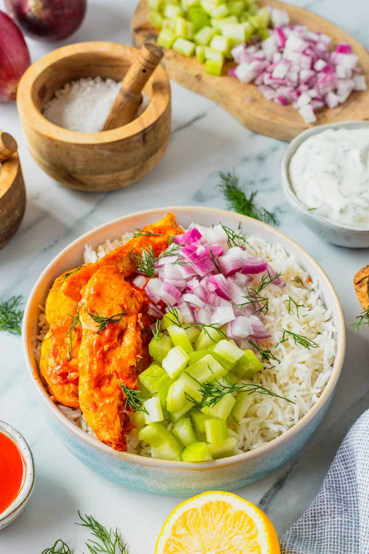 This Buffalo Chicken Bowl is the ultimate easy dinner recipe for busy weeknights, meal prep lunches, and game day food cravings. Tender chicken tossed in spicy Buffalo sauce is served over fluffy white rice and topped with crisp celery, red onion, and a creamy homemade ranch dressing for the perfect balance of heat and freshness. If you're looking for healthy chicken bowl recipes, Buffalo chicken rice bowls, easy meal prep ideas, or quick family dinner recipes, this dish checks every box. Packed with protein, loaded with flavor, and ready in just 30 minutes, these Buffalo Chicken Bowls are a satisfying comfort food meal that feels restaurant-worthy while being simple enough to make at home any night of the week.