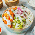 This Buffalo Chicken Bowl is the ultimate easy dinner recipe for busy weeknights, meal prep lunches, and game day food cravings. Tender chicken tossed in spicy Buffalo sauce is served over fluffy white rice and topped with crisp celery, red onion, and a creamy homemade ranch dressing for the perfect balance of heat and freshness. If you're looking for healthy chicken bowl recipes, Buffalo chicken rice bowls, easy meal prep ideas, or quick family dinner recipes, this dish checks every box. Packed with protein, loaded with flavor, and ready in just 30 minutes, these Buffalo Chicken Bowls are a satisfying comfort food meal that feels restaurant-worthy while being simple enough to make at home any night of the week.