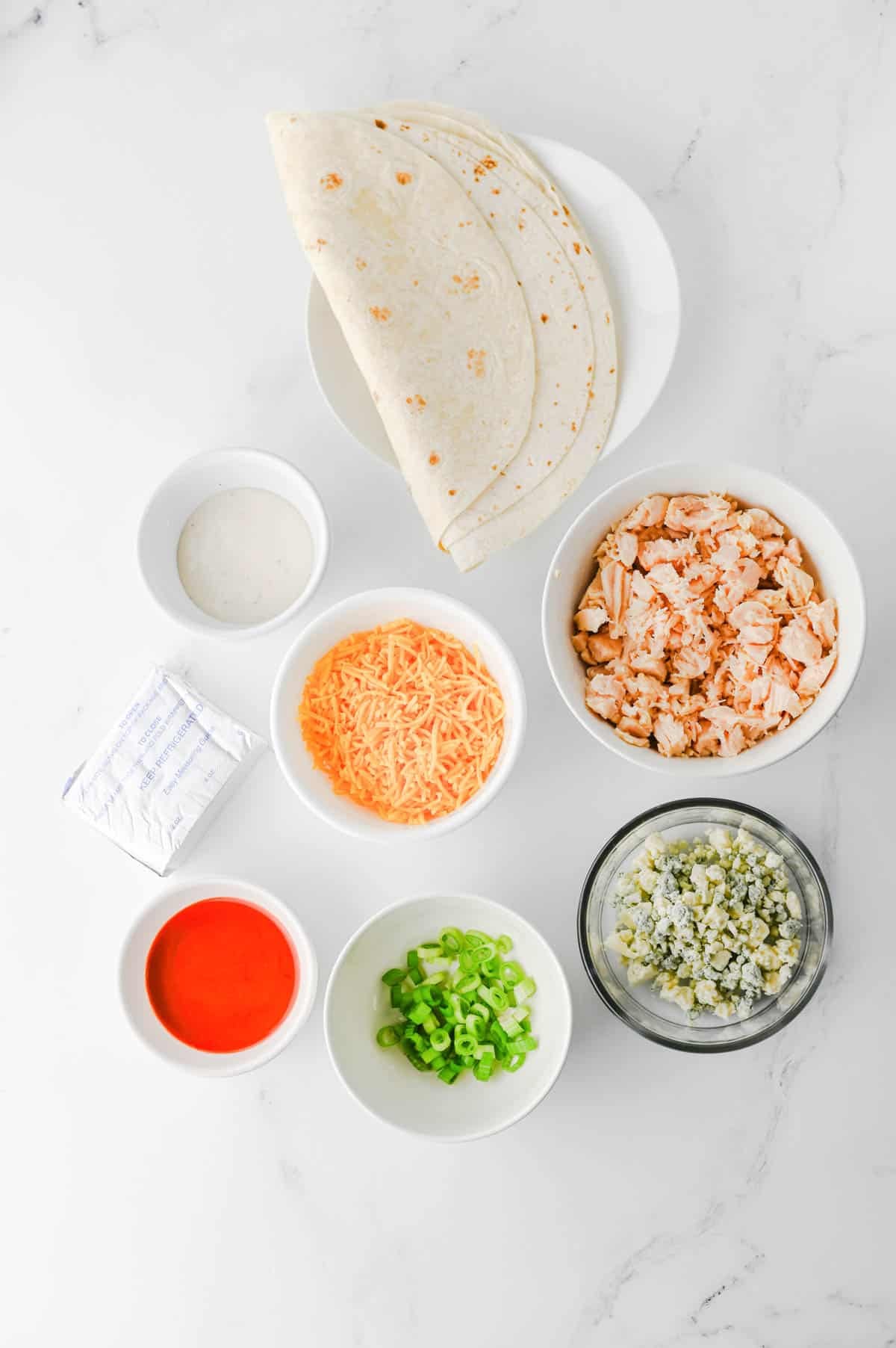 buffalo chicken pinwheel ingredients on the kitchen counter