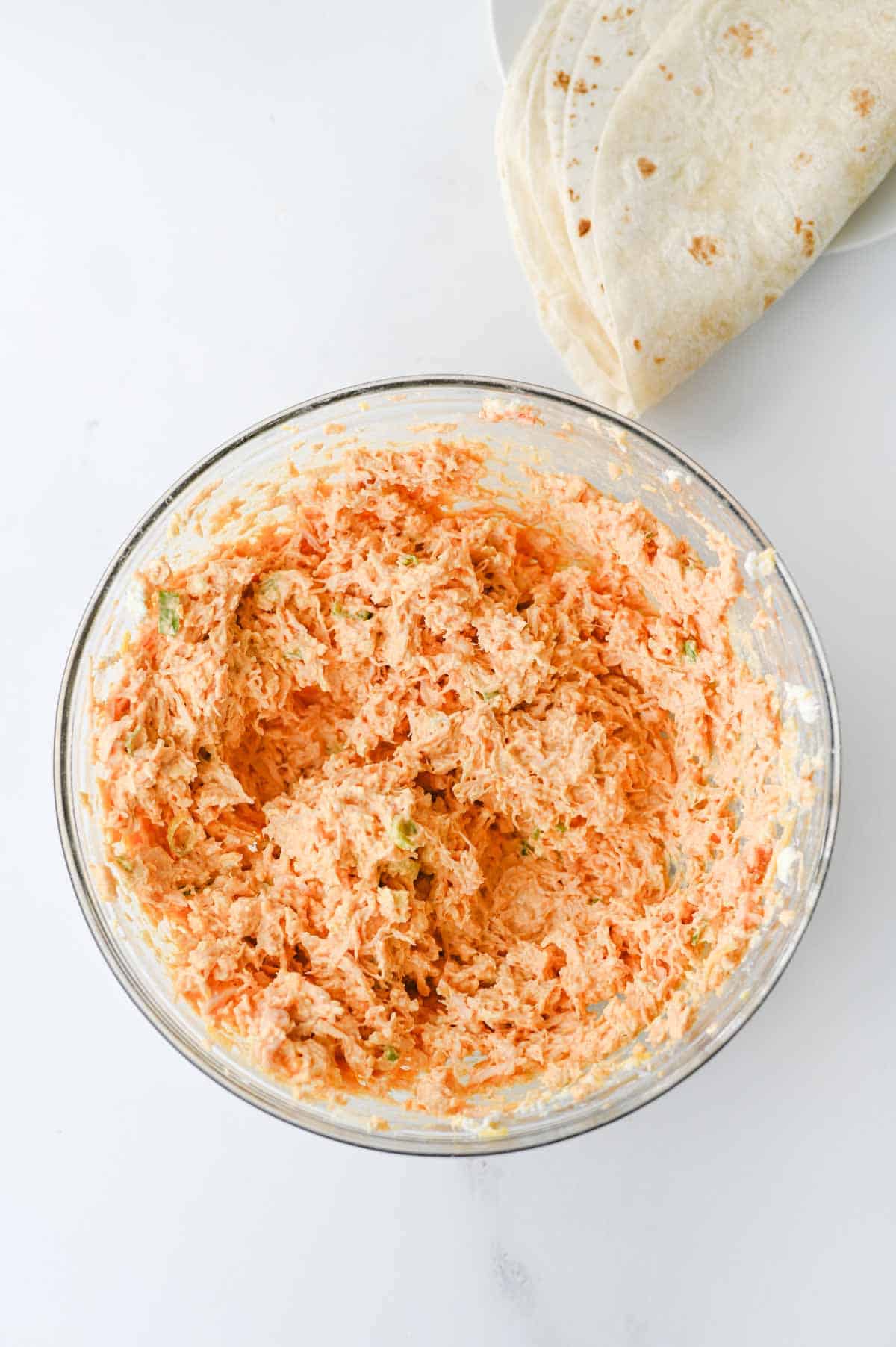 creamy buffalo chicken mixture in a mixing bowl