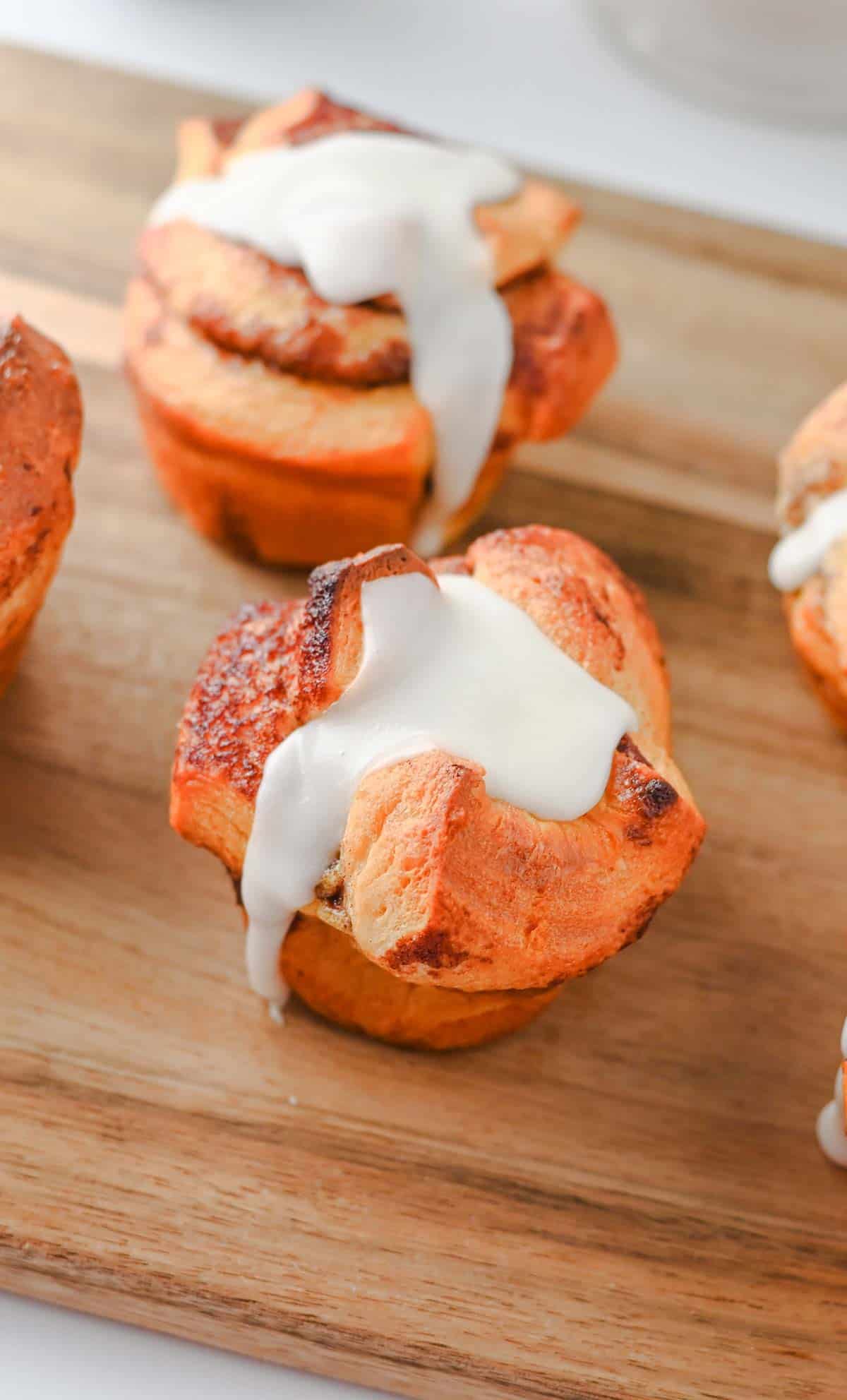These Cinnamon Roll Muffins are the ultimate easy breakfast recipe for busy mornings, holiday brunches and weekend baking. Made with Pillsbury cinnamon rolls, eggs, heavy cream, cinnamon and vanilla, these soft and fluffy muffins have all the flavour of classic cinnamon rolls in a convenient grab-and-go form. The chopped cinnamon roll pieces bake up perfectly in muffin tins while the rich custard mixture creates a tender, bakery-style texture. Once baked, they're topped with the sweet cream cheese frosting for an irresistible finish. Whether you're looking for an easy brunch recipe, a simple make-ahead breakfast or a fun twist on canned cinnamon rolls, these Cinnamon Roll Muffins are guaranteed to be a family favourite.