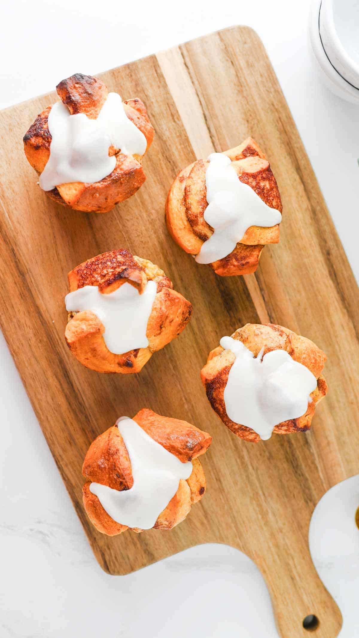These Cinnamon Roll Muffins are the ultimate easy breakfast recipe for busy mornings, holiday brunches and weekend baking. Made with Pillsbury cinnamon rolls, eggs, heavy cream, cinnamon and vanilla, these soft and fluffy muffins have all the flavour of classic cinnamon rolls in a convenient grab-and-go form. The chopped cinnamon roll pieces bake up perfectly in muffin tins while the rich custard mixture creates a tender, bakery-style texture. Once baked, they're topped with the sweet cream cheese frosting for an irresistible finish. Whether you're looking for an easy brunch recipe, a simple make-ahead breakfast or a fun twist on canned cinnamon rolls, these Cinnamon Roll Muffins are guaranteed to be a family favourite.