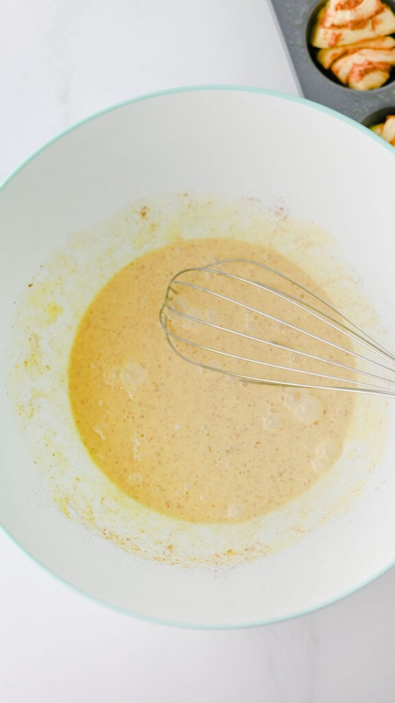whisking eggs, heavy cream, vanilla and cinnamon together in a bwol