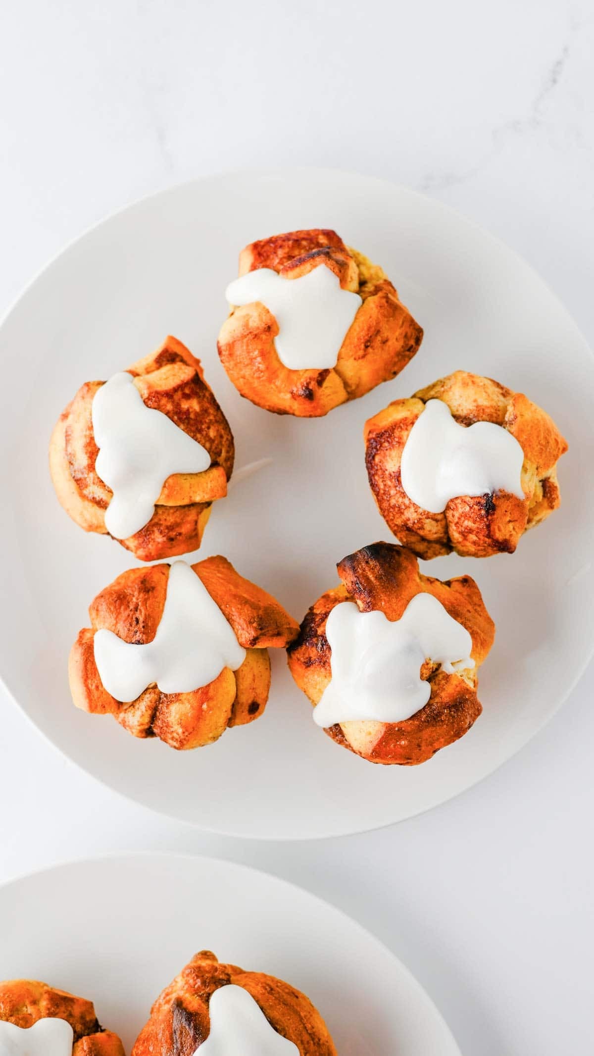 These Cinnamon Roll Muffins are the ultimate easy breakfast recipe for busy mornings, holiday brunches and weekend baking. Made with Pillsbury cinnamon rolls, eggs, heavy cream, cinnamon and vanilla, these soft and fluffy muffins have all the flavour of classic cinnamon rolls in a convenient grab-and-go form. The chopped cinnamon roll pieces bake up perfectly in muffin tins while the rich custard mixture creates a tender, bakery-style texture. Once baked, they're topped with the sweet cream cheese frosting for an irresistible finish. Whether you're looking for an easy brunch recipe, a simple make-ahead breakfast or a fun twist on canned cinnamon rolls, these Cinnamon Roll Muffins are guaranteed to be a family favourite.