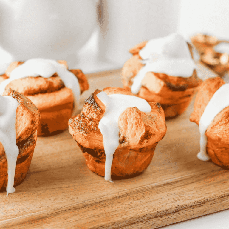 These Cinnamon Roll Muffins are the ultimate easy breakfast recipe for busy mornings, holiday brunches and weekend baking. Made with Pillsbury cinnamon rolls, eggs, heavy cream, cinnamon and vanilla, these soft and fluffy muffins have all the flavour of classic cinnamon rolls in a convenient grab-and-go form. The chopped cinnamon roll pieces bake up perfectly in muffin tins while the rich custard mixture creates a tender, bakery-style texture. Once baked, they're topped with the sweet cream cheese frosting for an irresistible finish. Whether you're looking for an easy brunch recipe, a simple make-ahead breakfast or a fun twist on canned cinnamon rolls, these Cinnamon Roll Muffins are guaranteed to be a family favourite.