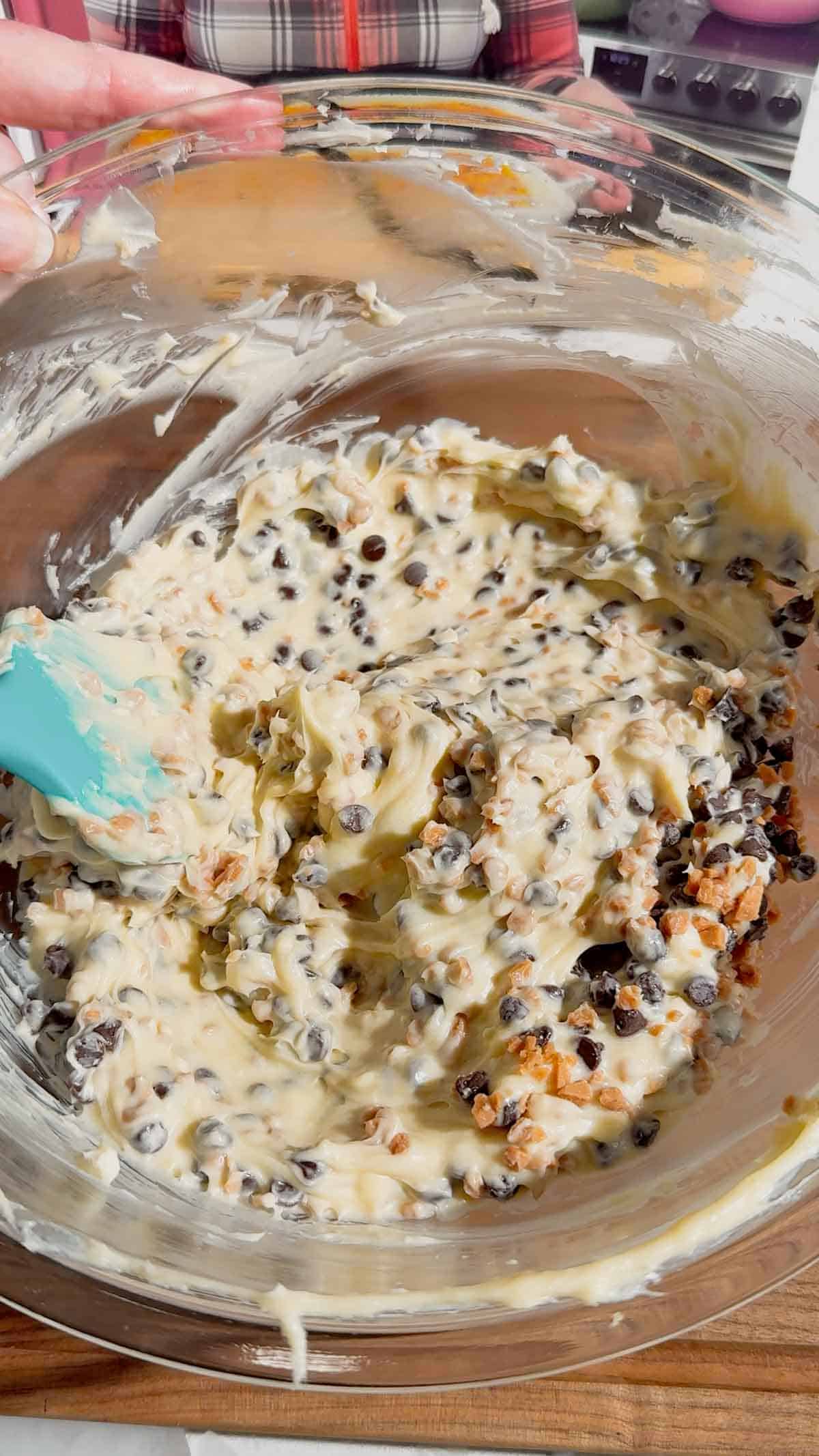 stirring chocolate chips and toffee bits into cream cheese and butter mixture