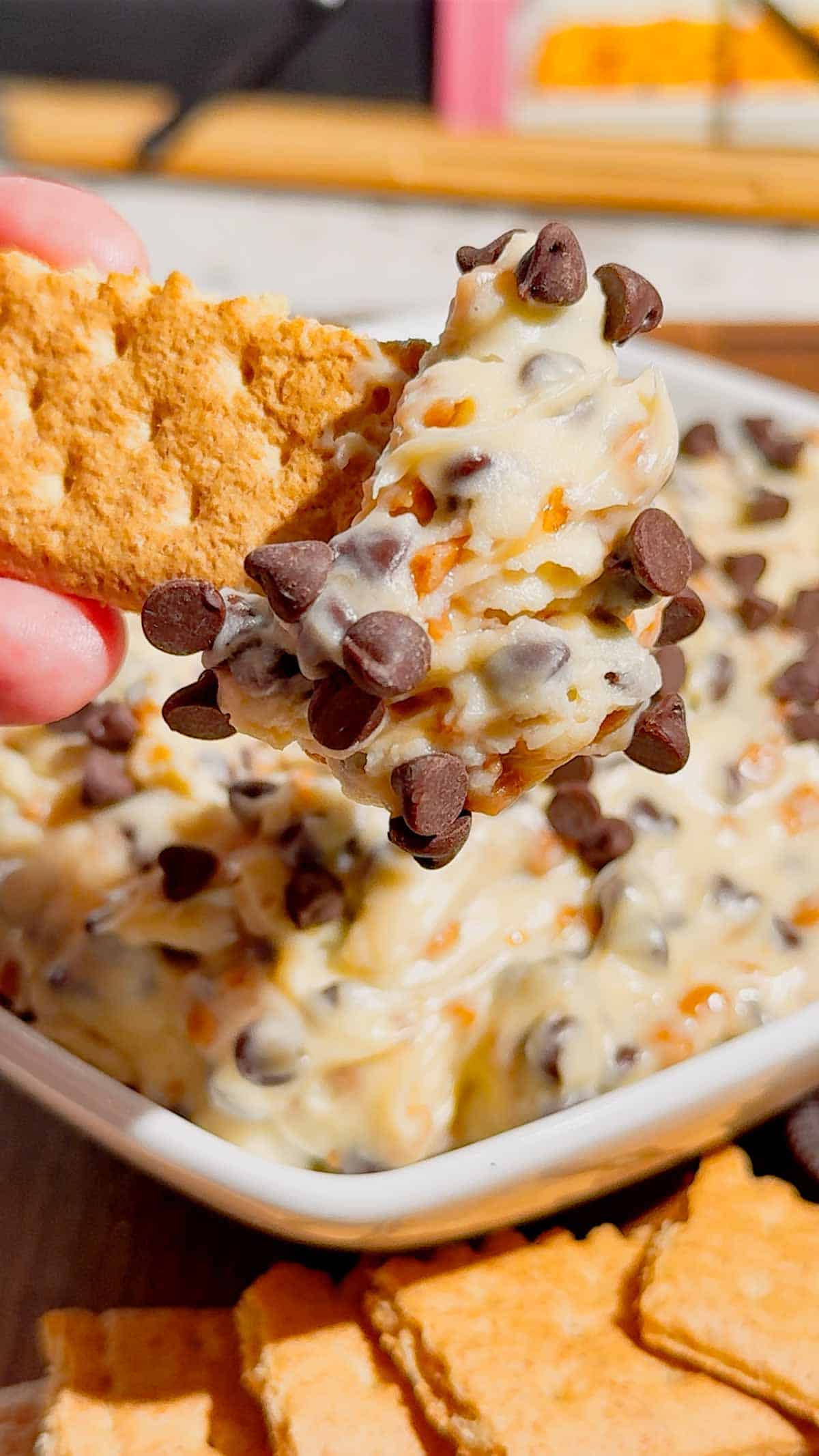 Looking for the ultimate Cookie Dough Dip recipe? This easy No Bake Dessert Dip is rich, creamy, and loaded with mini chocolate chips and crunchy toffee bits for the perfect sweet treat. Ready in just 10 minutes, this Chocolate Chip Cookie Dough Dip is ideal for parties, game day, movie nights, birthdays, potlucks, holiday dessert tables, and family gatherings. Serve it with graham crackers, vanilla wafers, pretzels, apple slices, strawberries, or cookies for an irresistible dessert everyone will love. If you need an easy dessert dip, sweet party snack, no bake dessert recipe, or crowd-pleasing treat, this homemade cookie dough dip is guaranteed to disappear fast and become a favorite for every occasion.