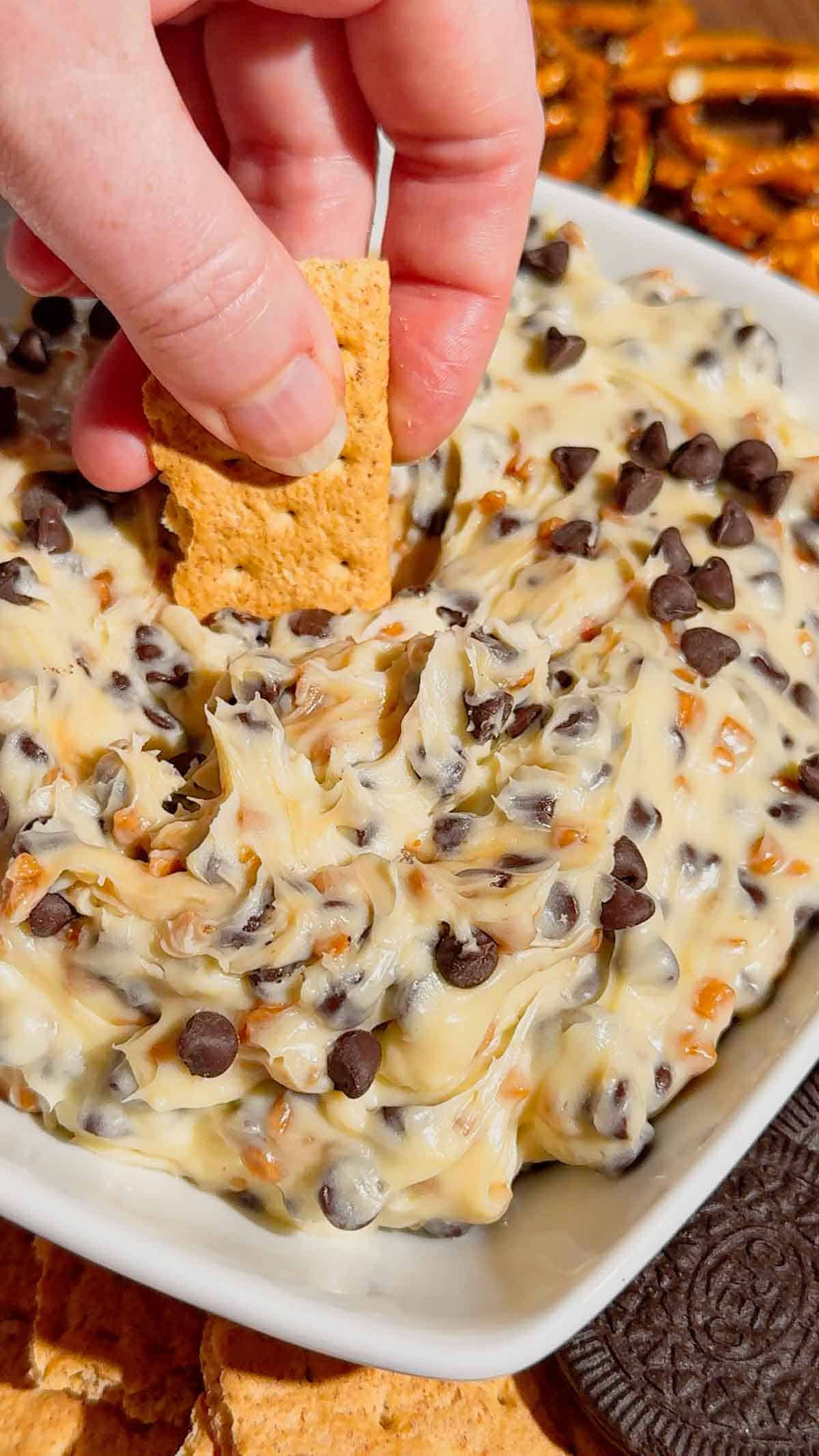Looking for the ultimate Cookie Dough Dip recipe? This easy No Bake Dessert Dip is rich, creamy, and loaded with mini chocolate chips and crunchy toffee bits for the perfect sweet treat. Ready in just 10 minutes, this Chocolate Chip Cookie Dough Dip is ideal for parties, game day, movie nights, birthdays, potlucks, holiday dessert tables, and family gatherings. Serve it with graham crackers, vanilla wafers, pretzels, apple slices, strawberries, or cookies for an irresistible dessert everyone will love. If you need an easy dessert dip, sweet party snack, no bake dessert recipe, or crowd-pleasing treat, this homemade cookie dough dip is guaranteed to disappear fast and become a favorite for every occasion.