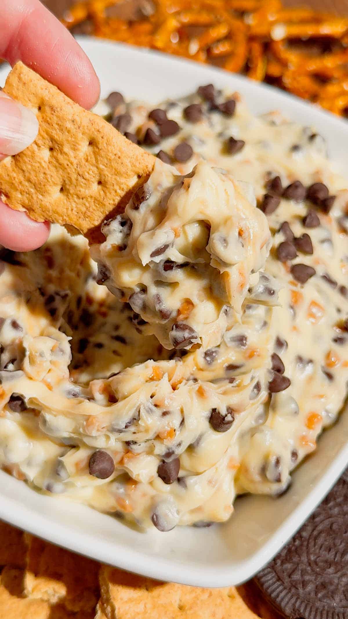 Looking for the ultimate Cookie Dough Dip recipe? This easy No Bake Dessert Dip is rich, creamy, and loaded with mini chocolate chips and crunchy toffee bits for the perfect sweet treat. Ready in just 10 minutes, this Chocolate Chip Cookie Dough Dip is ideal for parties, game day, movie nights, birthdays, potlucks, holiday dessert tables, and family gatherings. Serve it with graham crackers, vanilla wafers, pretzels, apple slices, strawberries, or cookies for an irresistible dessert everyone will love. If you need an easy dessert dip, sweet party snack, no bake dessert recipe, or crowd-pleasing treat, this homemade cookie dough dip is guaranteed to disappear fast and become a favorite for every occasion.
