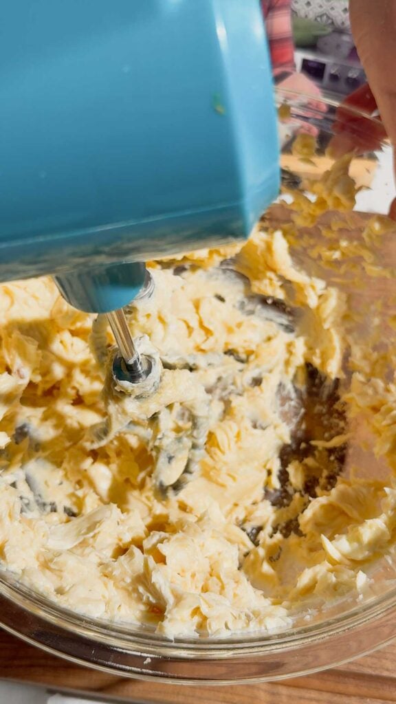 electric mixer whipping cream cheese, butter and sugar together