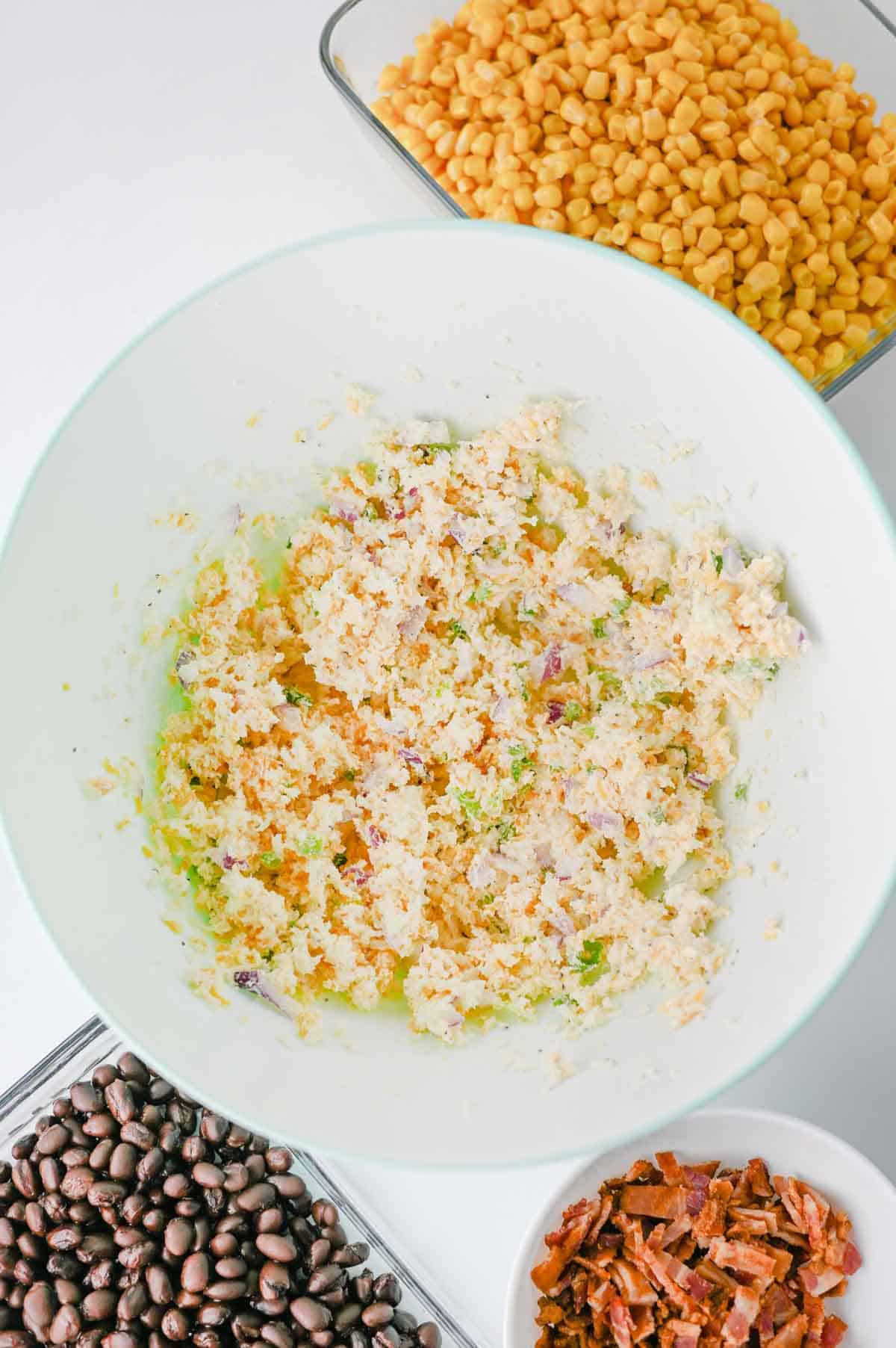 cream cheese, mayo, shredded cheese and green onions stirred together in a mixing bowl