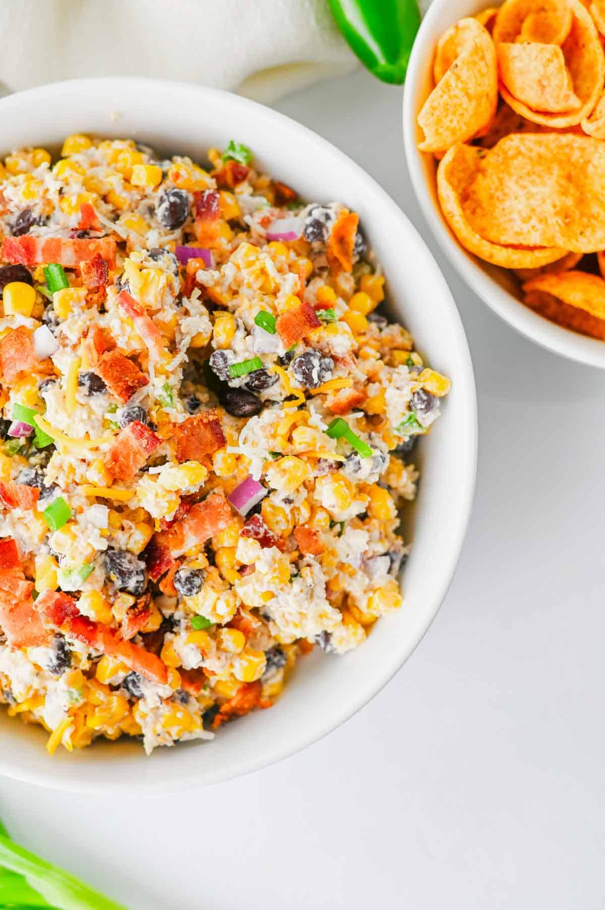 Cowboy Corn Dip is the ultimate party appetizer loaded with sweet corn, black beans, crispy bacon, shredded cheese, jalapeños, and a creamy dressing that comes together in minutes. This easy corn dip recipe is perfect for game day snacks, summer BBQs, potlucks, tailgates, and family gatherings. If you're searching for Corn Dip Recipes, Cold Corn Dip, Mexican Corn Dip, Easy Party Dips, Creamy Corn Dip, Bacon Corn Dip, Corn And Black Bean Dip, Game Day Appetizers, Potluck Recipes, or Crowd Pleasing Snack Ideas, this recipe is a must-try. Serve it with tortilla chips, crackers, or fresh veggies for a delicious appetizer everyone will be coming back for. Quick to make, packed with flavor, and always a hit, this cheesy cowboy dip belongs at every party table.