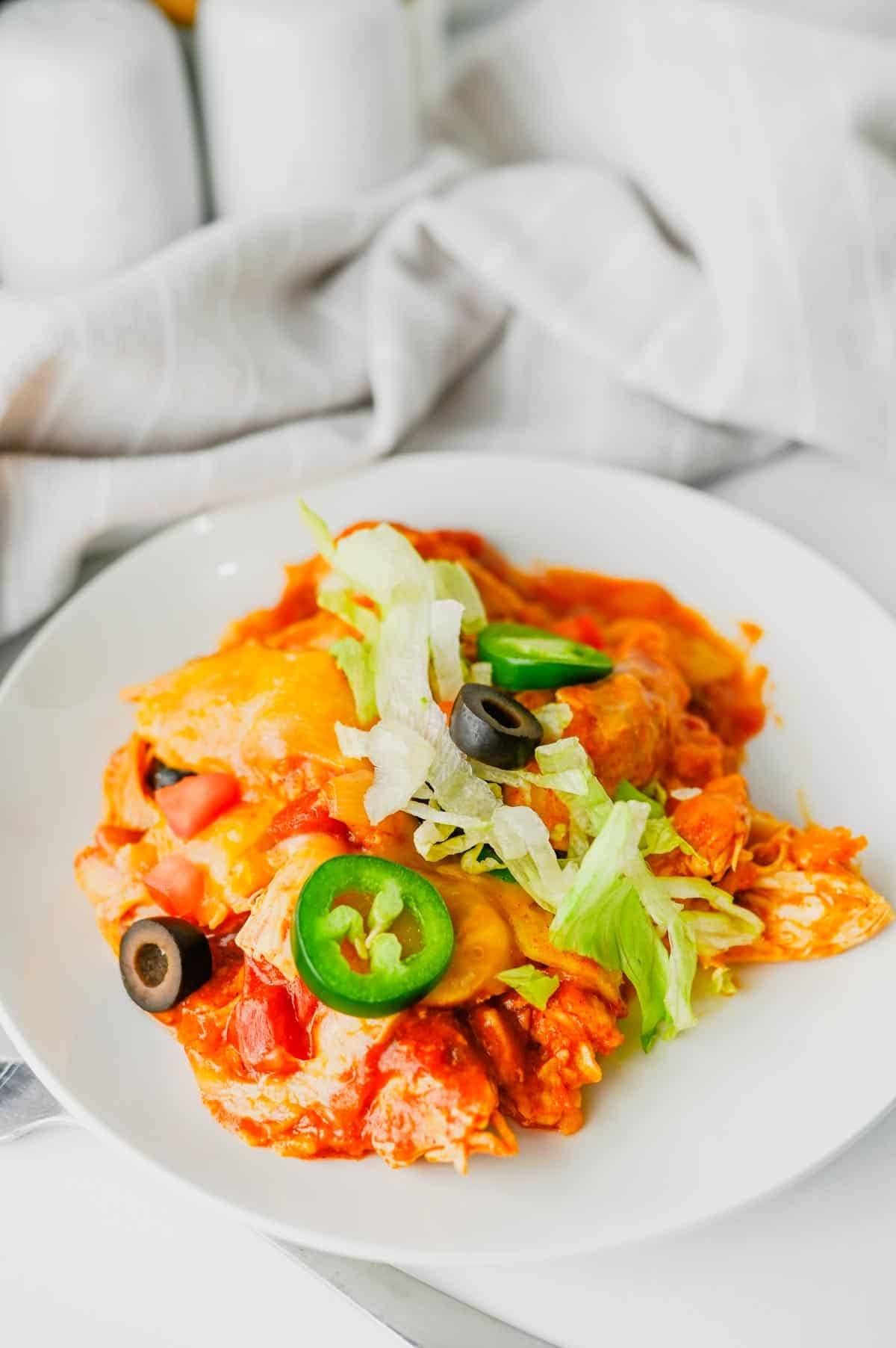 This Crock Pot Chicken Enchilada Casserole is the ultimate easy family dinner packed with tender shredded chicken, enchilada sauce, corn tortillas, Rotel tomatoes, and melted Mexican cheese. If you're looking for Crockpot Chicken Recipes, Slow Cooker Chicken Recipes, Easy Crockpot Meals, or Dump And Go Crockpot Dinners, this simple recipe is a must-try. Perfect for busy weeknights, meal prep, and feeding a hungry family, this cheesy casserole delivers all the flavors of classic chicken enchiladas with minimal effort. Whether you love Mexican Casserole Recipes, Chicken Enchilada Casserole, Crockpot Mexican Chicken, Easy Dinner Recipes, or Comfort Food Dinners, this hearty meal is guaranteed to become a regular part of your dinner rotation. Save this delicious slow cooker recipe for later!