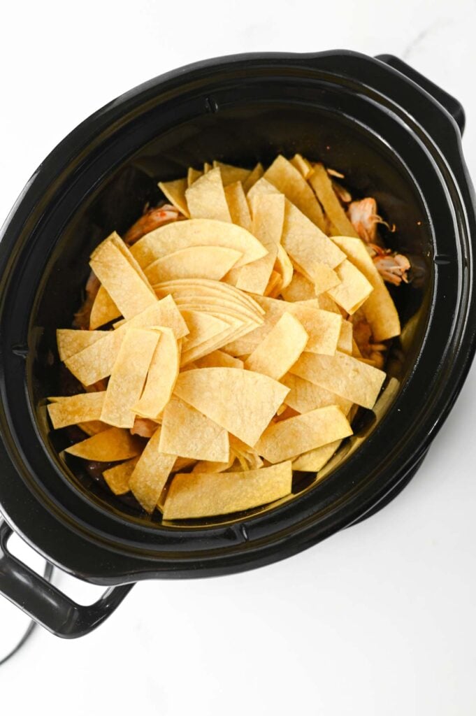 corn tortilla strips added to slow cooker