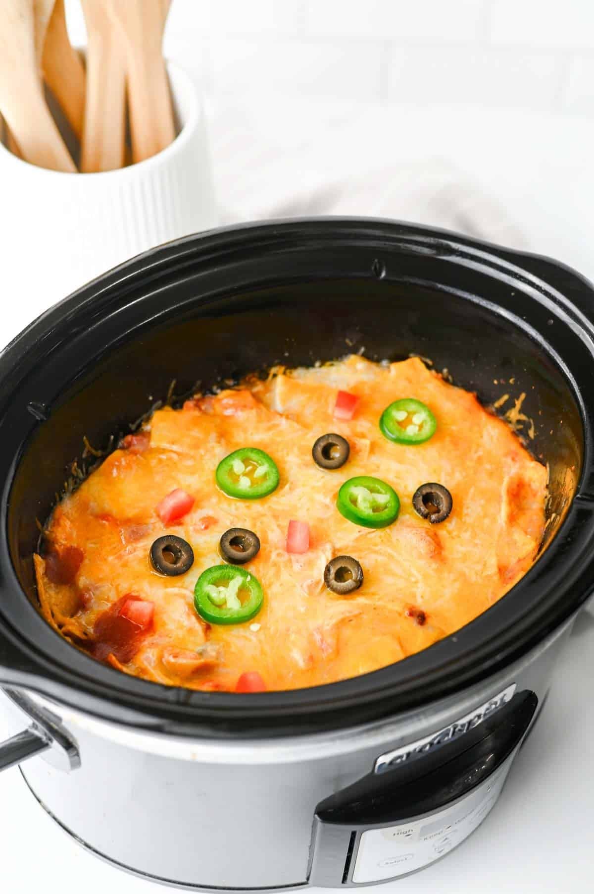 This Crock Pot Chicken Enchilada Casserole is the ultimate easy family dinner packed with tender shredded chicken, enchilada sauce, corn tortillas, Rotel tomatoes, and melted Mexican cheese. If you're looking for Crockpot Chicken Recipes, Slow Cooker Chicken Recipes, Easy Crockpot Meals, or Dump And Go Crockpot Dinners, this simple recipe is a must-try. Perfect for busy weeknights, meal prep, and feeding a hungry family, this cheesy casserole delivers all the flavors of classic chicken enchiladas with minimal effort. Whether you love Mexican Casserole Recipes, Chicken Enchilada Casserole, Crockpot Mexican Chicken, Easy Dinner Recipes, or Comfort Food Dinners, this hearty meal is guaranteed to become a regular part of your dinner rotation. Save this delicious slow cooker recipe for later!