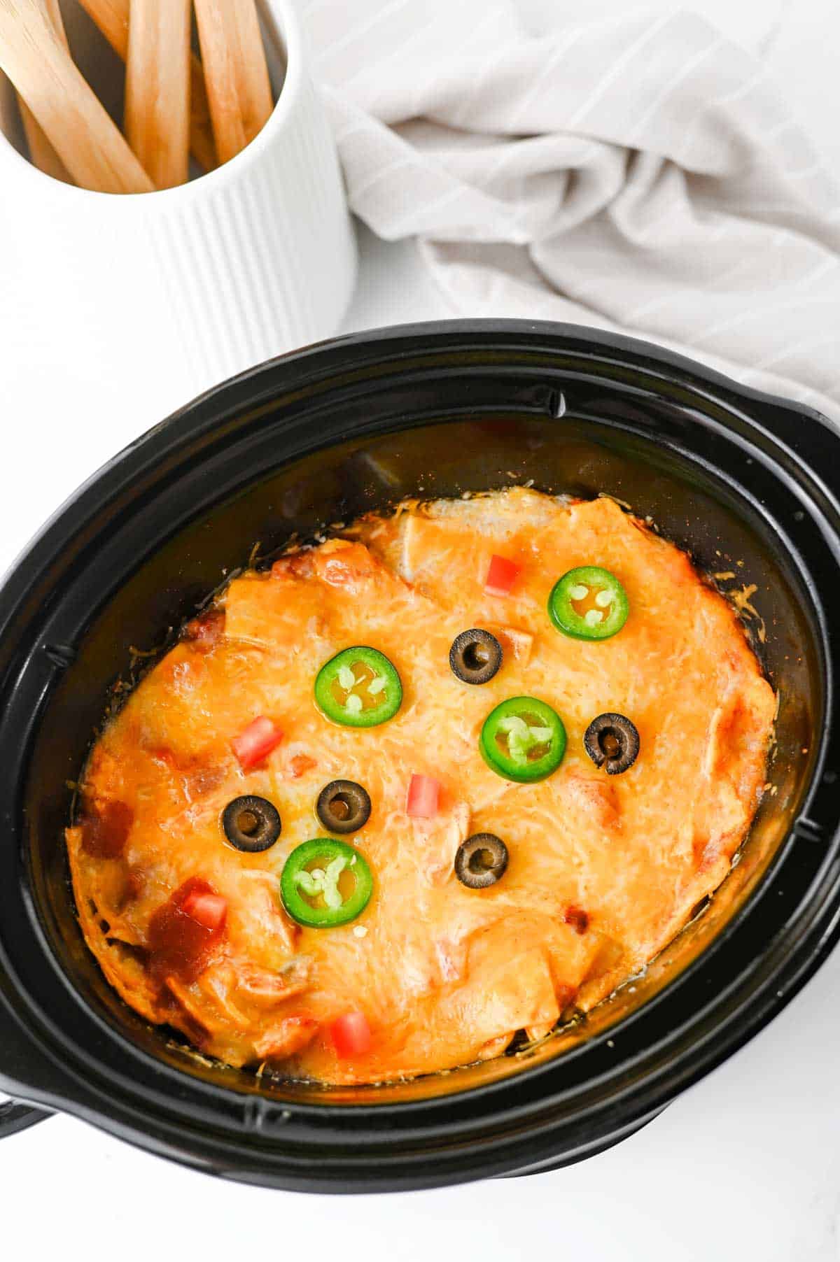 This Crock Pot Chicken Enchilada Casserole is the ultimate easy family dinner packed with tender shredded chicken, enchilada sauce, corn tortillas, Rotel tomatoes, and melted Mexican cheese. If you're looking for Crockpot Chicken Recipes, Slow Cooker Chicken Recipes, Easy Crockpot Meals, or Dump And Go Crockpot Dinners, this simple recipe is a must-try. Perfect for busy weeknights, meal prep, and feeding a hungry family, this cheesy casserole delivers all the flavors of classic chicken enchiladas with minimal effort. Whether you love Mexican Casserole Recipes, Chicken Enchilada Casserole, Crockpot Mexican Chicken, Easy Dinner Recipes, or Comfort Food Dinners, this hearty meal is guaranteed to become a regular part of your dinner rotation. Save this delicious slow cooker recipe for later!