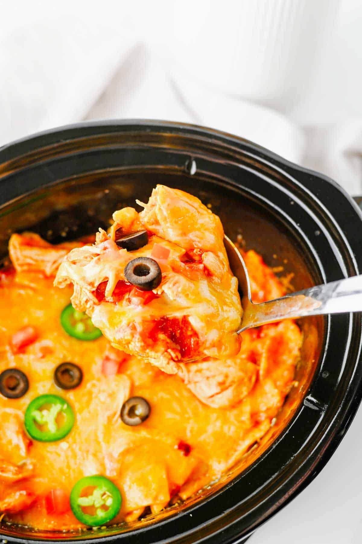 This Crock Pot Chicken Enchilada Casserole is the ultimate easy family dinner packed with tender shredded chicken, enchilada sauce, corn tortillas, Rotel tomatoes, and melted Mexican cheese. If you're looking for Crockpot Chicken Recipes, Slow Cooker Chicken Recipes, Easy Crockpot Meals, or Dump And Go Crockpot Dinners, this simple recipe is a must-try. Perfect for busy weeknights, meal prep, and feeding a hungry family, this cheesy casserole delivers all the flavors of classic chicken enchiladas with minimal effort. Whether you love Mexican Casserole Recipes, Chicken Enchilada Casserole, Crockpot Mexican Chicken, Easy Dinner Recipes, or Comfort Food Dinners, this hearty meal is guaranteed to become a regular part of your dinner rotation. Save this delicious slow cooker recipe for later!