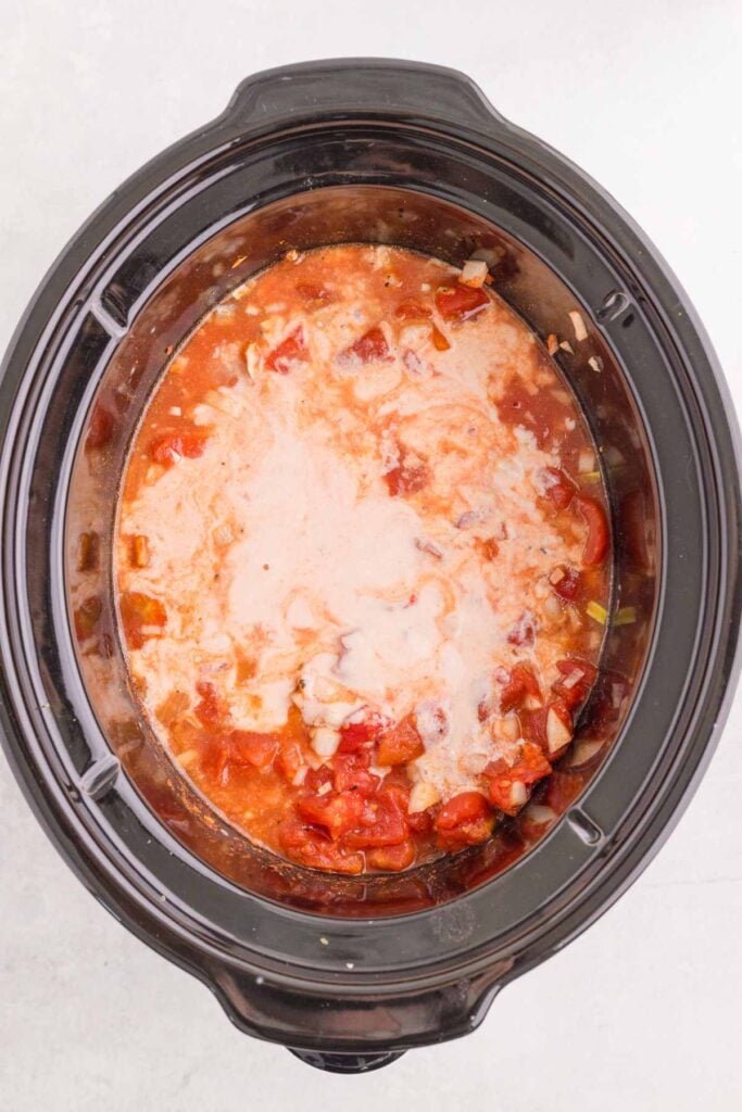 sour cream added to slow cooker with chicken paprikash