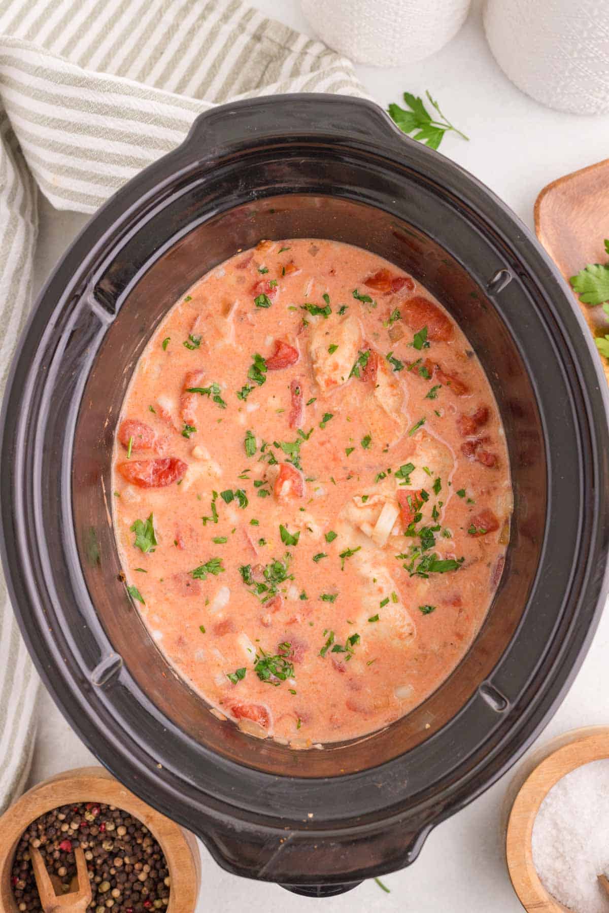 This Slow Cooker Chicken Paprikash is the ultimate comfort food dinner for busy weeknights. Tender chicken breasts cook low and slow with onions, tomatoes, and plenty of sweet paprika to create a rich, flavorful sauce that tastes like it simmered all day. A generous scoop of sour cream stirred in at the end gives this classic Hungarian-inspired dish its signature creamy texture. Serve it over egg noodles, rice, or mashed potatoes for a hearty family meal everyone will love. If you're looking for easy slow cooker chicken recipes, crock pot comfort food, cozy dinner ideas, or simple meals packed with flavor, this Chicken Paprikash recipe is a must-try. It's easy to prep, incredibly satisfying, and perfect for feeding a hungry crowd with minimal effort.