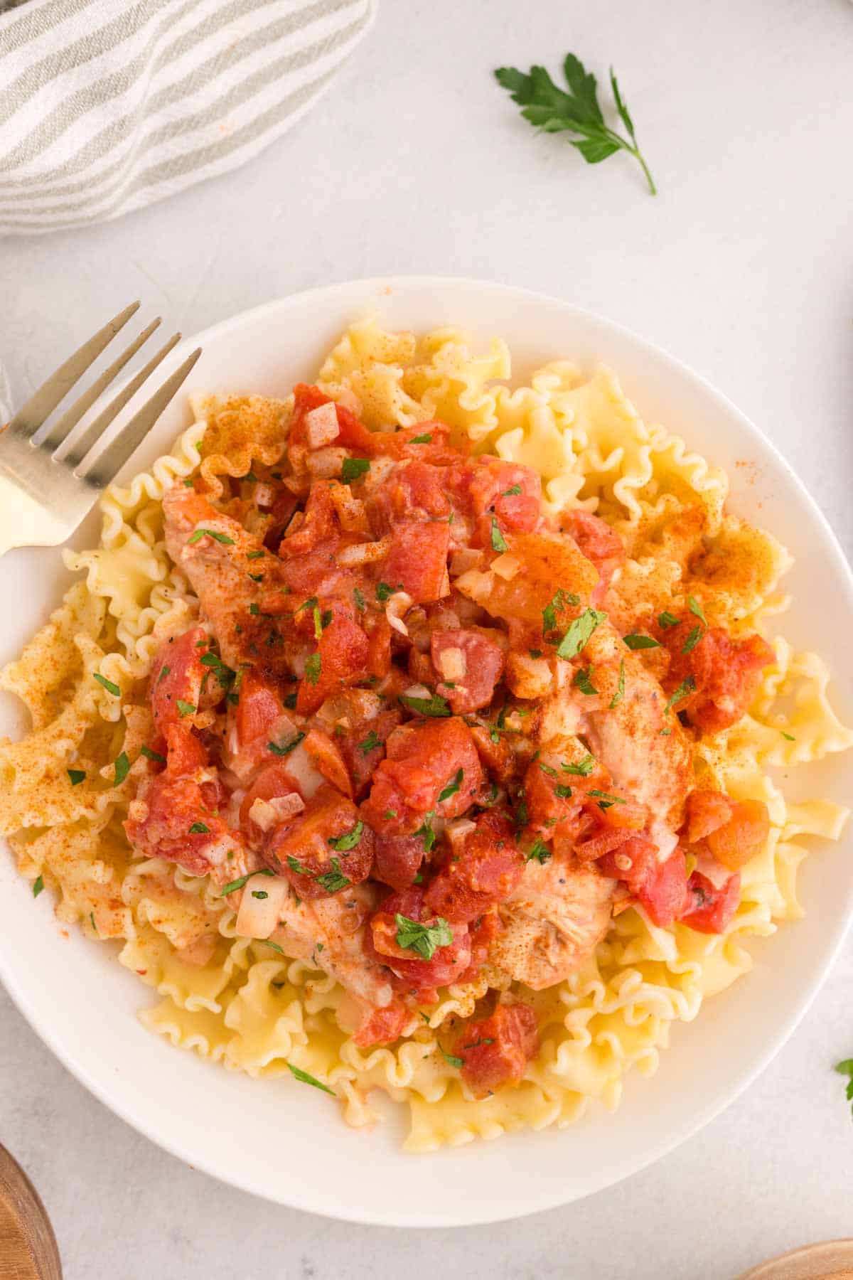 This Slow Cooker Chicken Paprikash is the ultimate comfort food dinner for busy weeknights. Tender chicken breasts cook low and slow with onions, tomatoes, and plenty of sweet paprika to create a rich, flavorful sauce that tastes like it simmered all day. A generous scoop of sour cream stirred in at the end gives this classic Hungarian-inspired dish its signature creamy texture. Serve it over egg noodles, rice, or mashed potatoes for a hearty family meal everyone will love. If you're looking for easy slow cooker chicken recipes, crock pot comfort food, cozy dinner ideas, or simple meals packed with flavor, this Chicken Paprikash recipe is a must-try. It's easy to prep, incredibly satisfying, and perfect for feeding a hungry crowd with minimal effort.