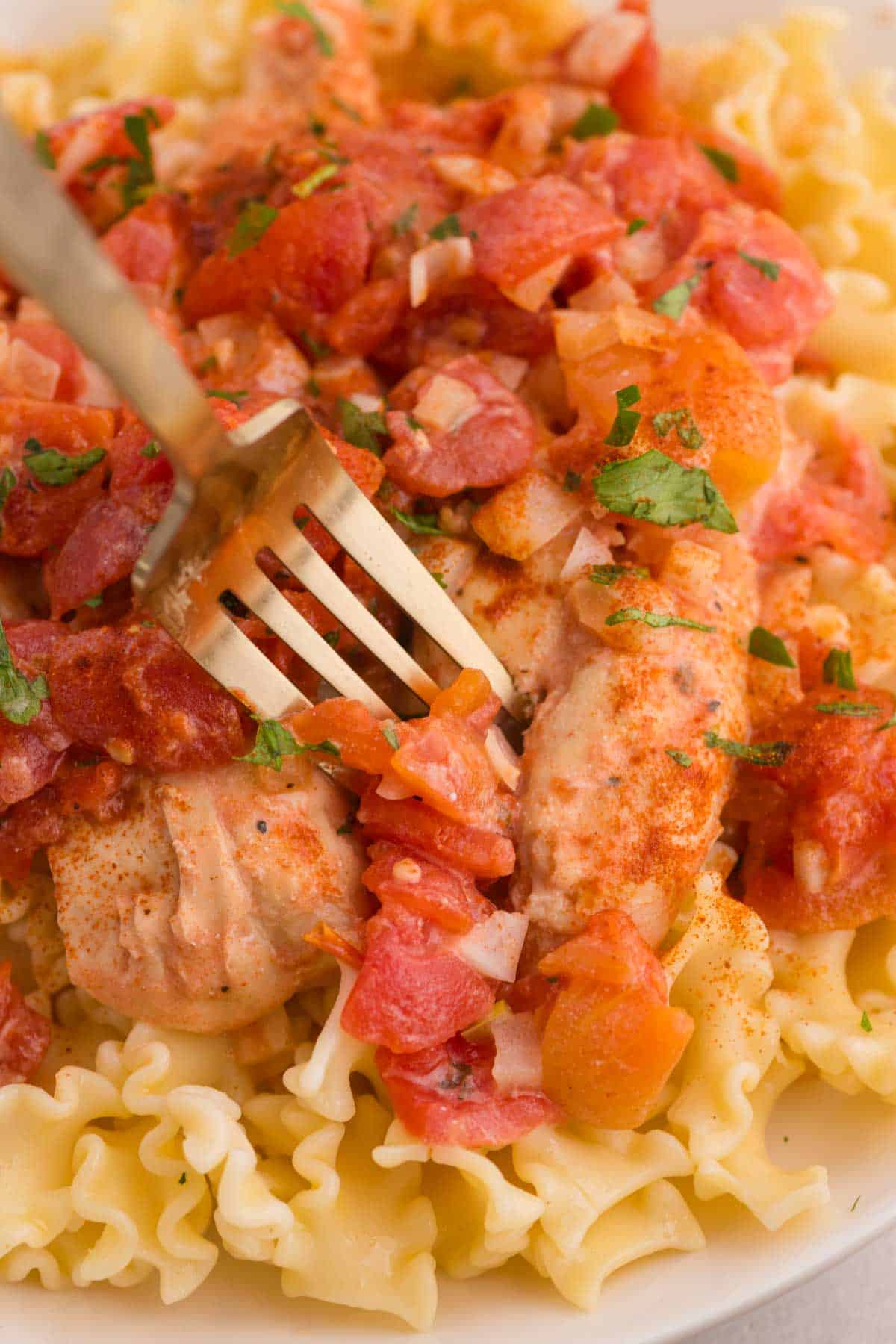 This Slow Cooker Chicken Paprikash is the ultimate comfort food dinner for busy weeknights. Tender chicken breasts cook low and slow with onions, tomatoes, and plenty of sweet paprika to create a rich, flavorful sauce that tastes like it simmered all day. A generous scoop of sour cream stirred in at the end gives this classic Hungarian-inspired dish its signature creamy texture. Serve it over egg noodles, rice, or mashed potatoes for a hearty family meal everyone will love. If you're looking for easy slow cooker chicken recipes, crock pot comfort food, cozy dinner ideas, or simple meals packed with flavor, this Chicken Paprikash recipe is a must-try. It's easy to prep, incredibly satisfying, and perfect for feeding a hungry crowd with minimal effort.