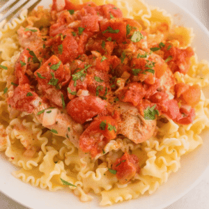 This Slow Cooker Chicken Paprikash is the ultimate comfort food dinner for busy weeknights. Tender chicken breasts cook low and slow with onions, tomatoes, and plenty of sweet paprika to create a rich, flavorful sauce that tastes like it simmered all day. A generous scoop of sour cream stirred in at the end gives this classic Hungarian-inspired dish its signature creamy texture. Serve it over egg noodles, rice, or mashed potatoes for a hearty family meal everyone will love. If you're looking for easy slow cooker chicken recipes, crock pot comfort food, cozy dinner ideas, or simple meals packed with flavor, this Chicken Paprikash recipe is a must-try. It's easy to prep, incredibly satisfying, and perfect for feeding a hungry crowd with minimal effort.