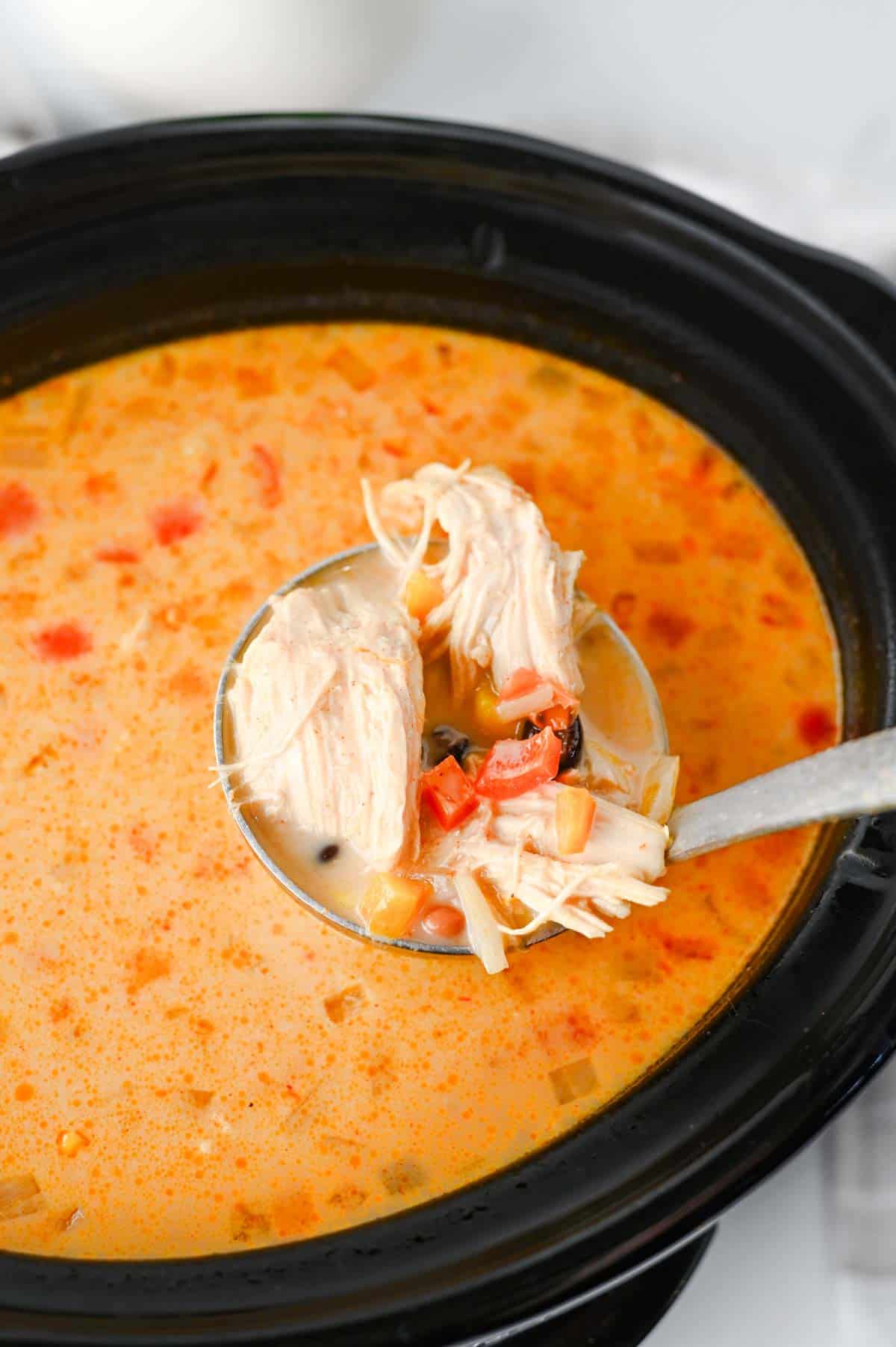 Warm up with this easy Crock Pot Chicken Tortilla Soup, a creamy and comforting dinner loaded with shredded chicken, black beans, pinto beans, corn, peppers, and bold Tex-Mex flavor. This Slow Cooker Chicken Tortilla Soup is the perfect dump-and-go meal for busy weeknights, meal prep, or cozy family dinners. Made with enchilada sauce, taco seasoning, and a splash of half and half, every spoonful is rich, hearty, and satisfying. Top it with crispy tortilla strips, shredded cheese, sour cream, avocado, or jalapeños for the ultimate bowl. If you're looking for easy crock pot soup recipes, slow cooker chicken recipes, or comforting fall and winter dinner ideas, this Chicken Tortilla Soup recipe is guaranteed to become a family favorite you'll make again and again.