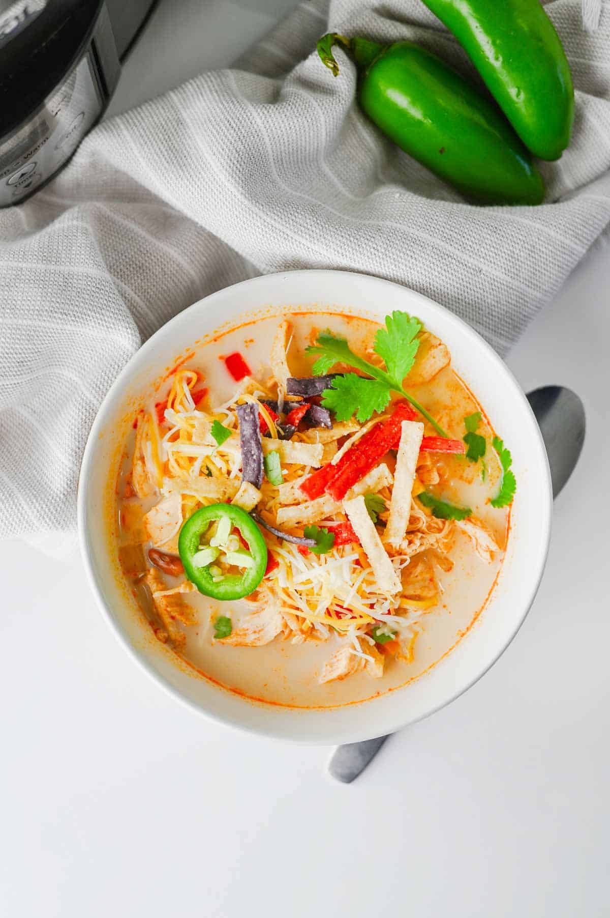 Warm up with this easy Crock Pot Chicken Tortilla Soup, a creamy and comforting dinner loaded with shredded chicken, black beans, pinto beans, corn, peppers, and bold Tex-Mex flavor. This Slow Cooker Chicken Tortilla Soup is the perfect dump-and-go meal for busy weeknights, meal prep, or cozy family dinners. Made with enchilada sauce, taco seasoning, and a splash of half and half, every spoonful is rich, hearty, and satisfying. Top it with crispy tortilla strips, shredded cheese, sour cream, avocado, or jalapeños for the ultimate bowl. If you're looking for easy crock pot soup recipes, slow cooker chicken recipes, or comforting fall and winter dinner ideas, this Chicken Tortilla Soup recipe is guaranteed to become a family favorite you'll make again and again.