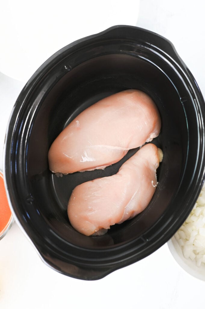 raw chicken breasts in a slow cooker