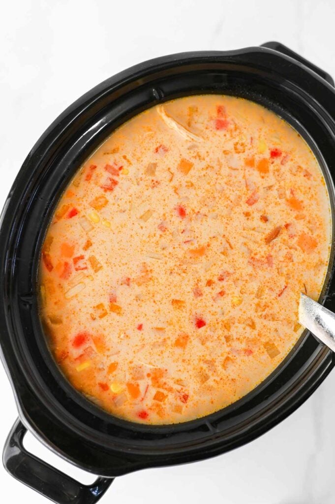 Warm up with this easy Crock Pot Chicken Tortilla Soup, a creamy and comforting dinner loaded with shredded chicken, black beans, pinto beans, corn, peppers, and bold Tex-Mex flavor. This Slow Cooker Chicken Tortilla Soup is the perfect dump-and-go meal for busy weeknights, meal prep, or cozy family dinners. Made with enchilada sauce, taco seasoning, and a splash of half and half, every spoonful is rich, hearty, and satisfying. Top it with crispy tortilla strips, shredded cheese, sour cream, avocado, or jalapeños for the ultimate bowl. If you're looking for easy crock pot soup recipes, slow cooker chicken recipes, or comforting fall and winter dinner ideas, this Chicken Tortilla Soup recipe is guaranteed to become a family favorite you'll make again and again.
