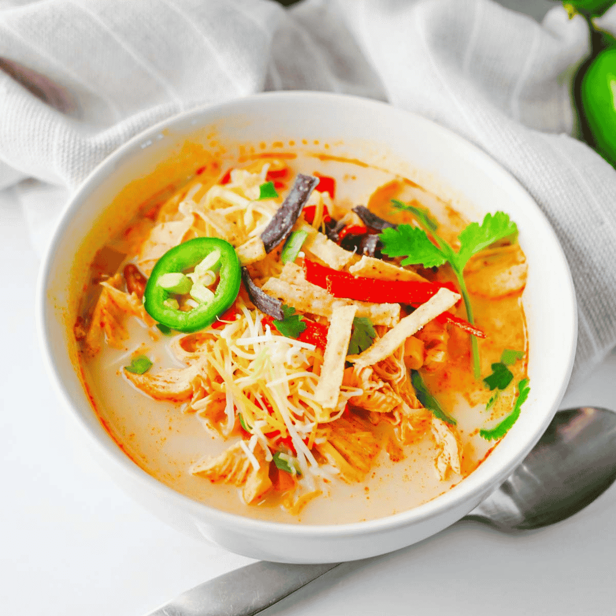 Warm up with this easy Crock Pot Chicken Tortilla Soup, a creamy and comforting dinner loaded with shredded chicken, black beans, pinto beans, corn, peppers, and bold Tex-Mex flavor. This Slow Cooker Chicken Tortilla Soup is the perfect dump-and-go meal for busy weeknights, meal prep, or cozy family dinners. Made with enchilada sauce, taco seasoning, and a splash of half and half, every spoonful is rich, hearty, and satisfying. Top it with crispy tortilla strips, shredded cheese, sour cream, avocado, or jalapeños for the ultimate bowl. If you're looking for easy crock pot soup recipes, slow cooker chicken recipes, or comforting fall and winter dinner ideas, this Chicken Tortilla Soup recipe is guaranteed to become a family favorite you'll make again and again.