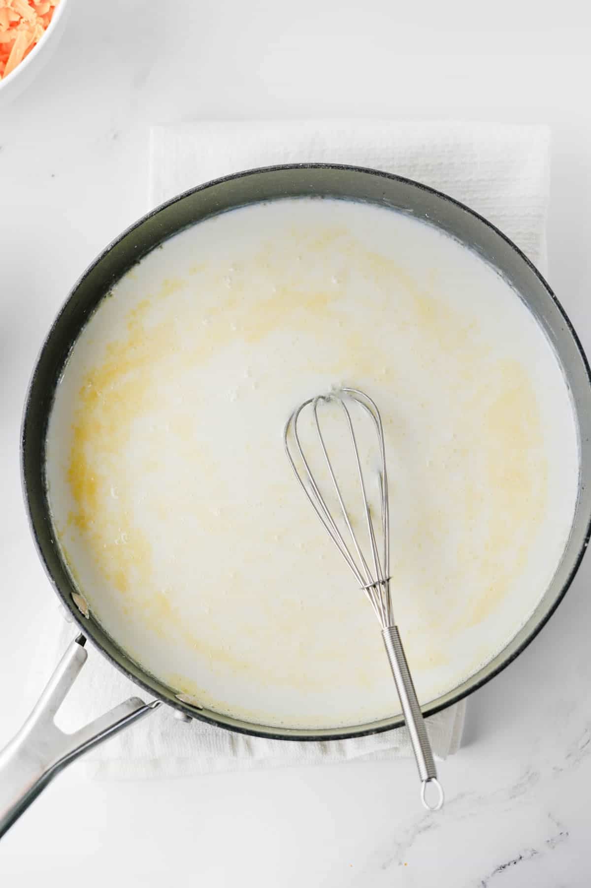 chicken broth and milk stirred into butter and flour mixture in a pot