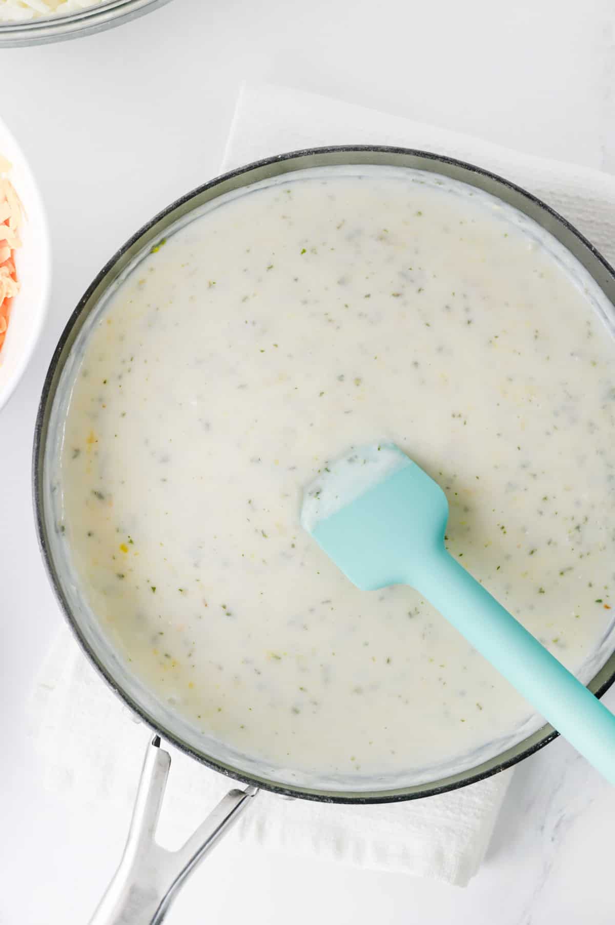 seasonings added to pot with milk, flour and butter mixture