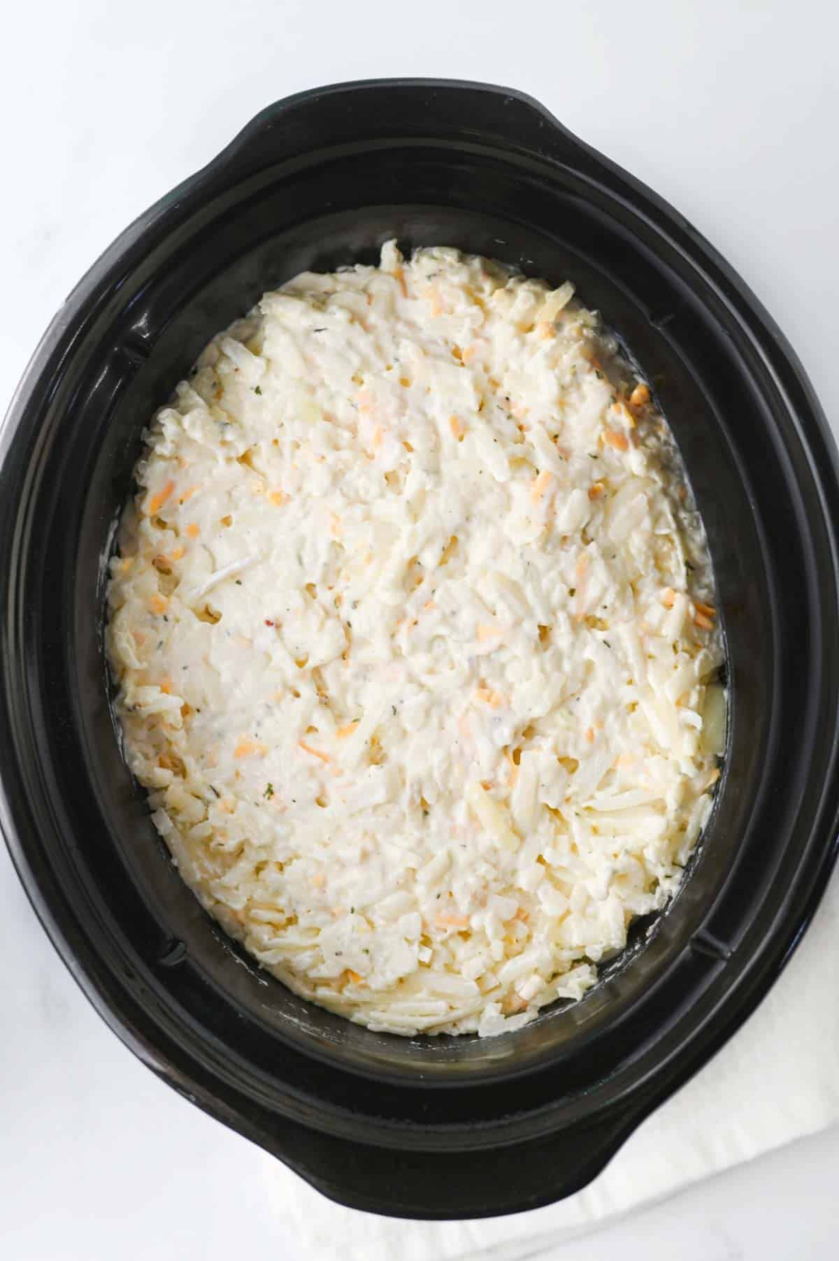 hashbrown casserole mixture in a crockpot before cooking