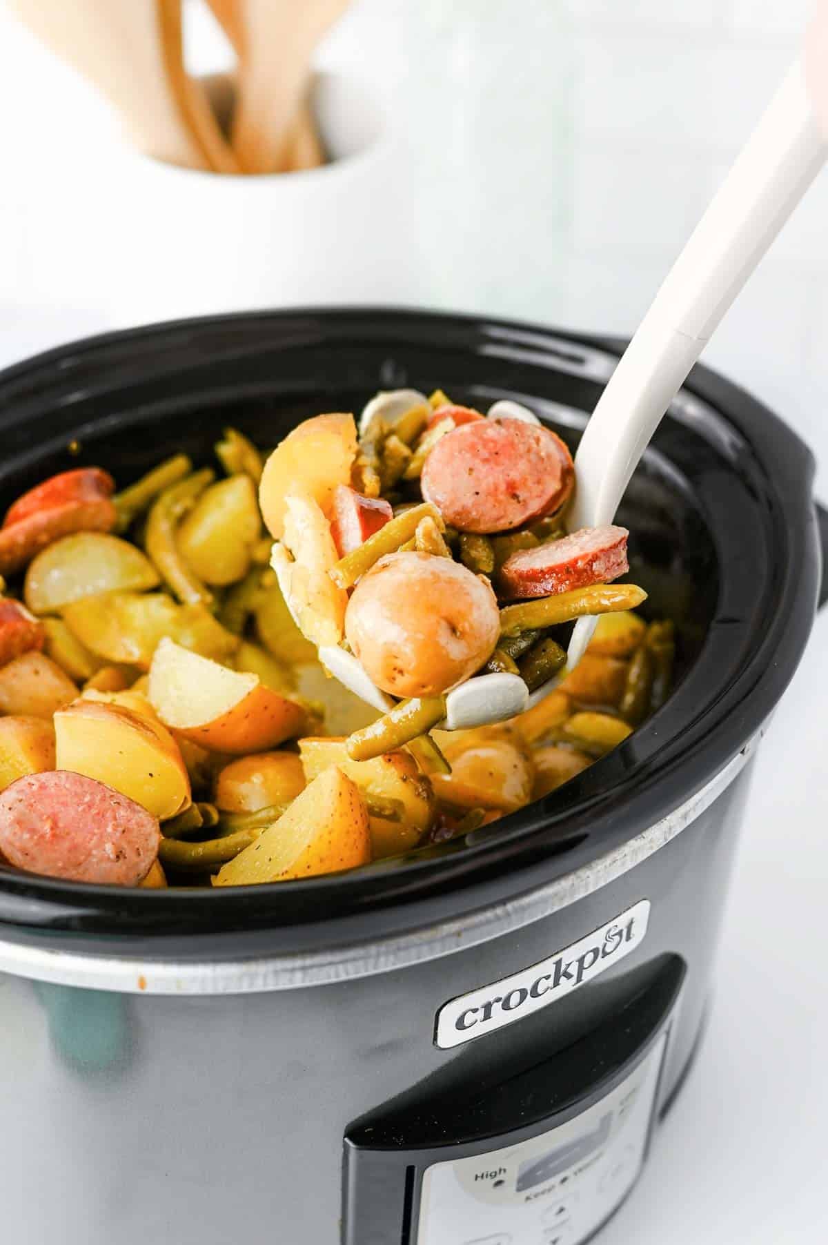 Looking for an easy slow cooker dinner the whole family will love? These Crock Pot Swamp Potatoes are loaded with tender baby potatoes, smoky sausage, green beans, buttery ranch flavor, and a kick of Cajun seasoning for a hearty meal that's packed with comfort. Everything cooks together in the crock pot, making this one of the easiest dump-and-go recipes for busy weeknights, lazy weekends, or cozy family dinners. If you love simple slow cooker recipes, sausage and potatoes, one pot meals, Southern-inspired comfort food, and budget-friendly dinners, this recipe deserves a spot on your menu. Serve it with crusty bread or enjoy it as a complete meal that's filling, flavorful, and guaranteed to have everyone coming back for seconds.