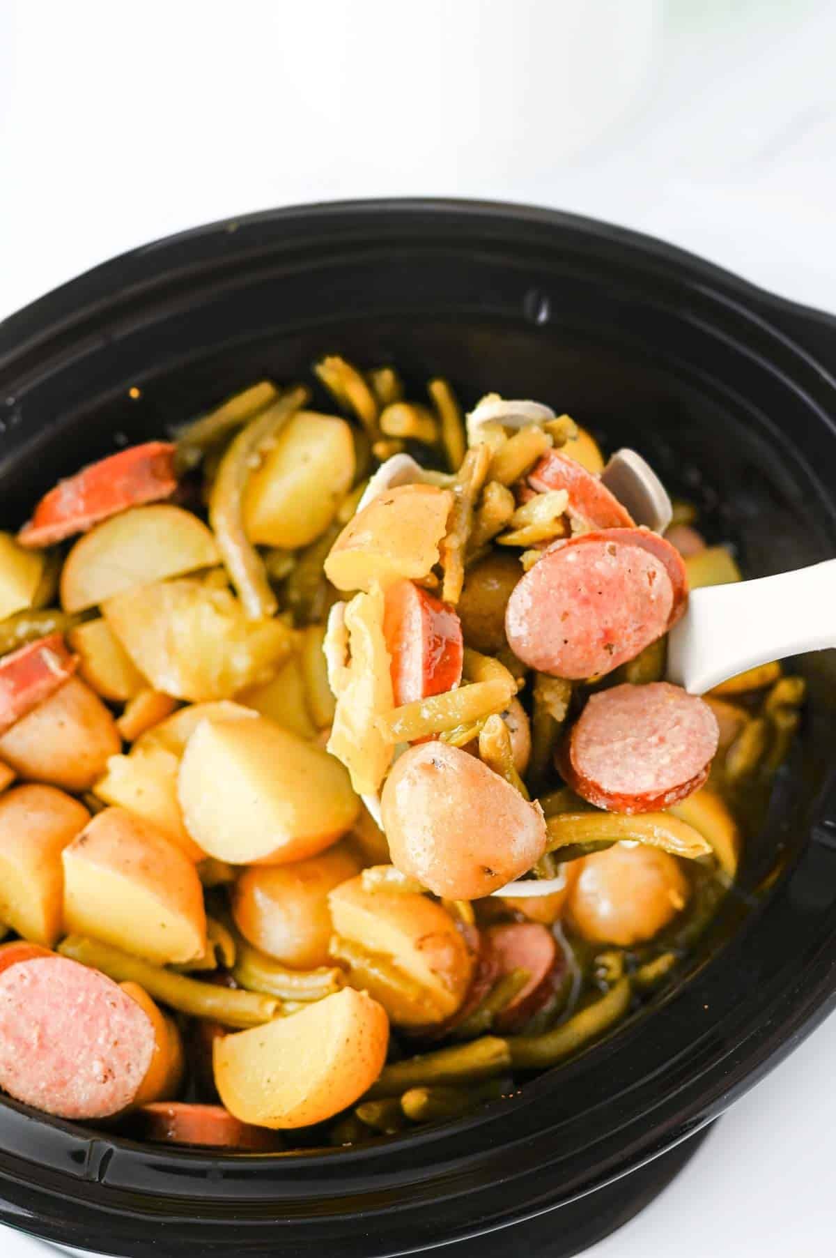 Looking for an easy slow cooker dinner the whole family will love? These Crock Pot Swamp Potatoes are loaded with tender baby potatoes, smoky sausage, green beans, buttery ranch flavor, and a kick of Cajun seasoning for a hearty meal that's packed with comfort. Everything cooks together in the crock pot, making this one of the easiest dump-and-go recipes for busy weeknights, lazy weekends, or cozy family dinners. If you love simple slow cooker recipes, sausage and potatoes, one pot meals, Southern-inspired comfort food, and budget-friendly dinners, this recipe deserves a spot on your menu. Serve it with crusty bread or enjoy it as a complete meal that's filling, flavorful, and guaranteed to have everyone coming back for seconds.