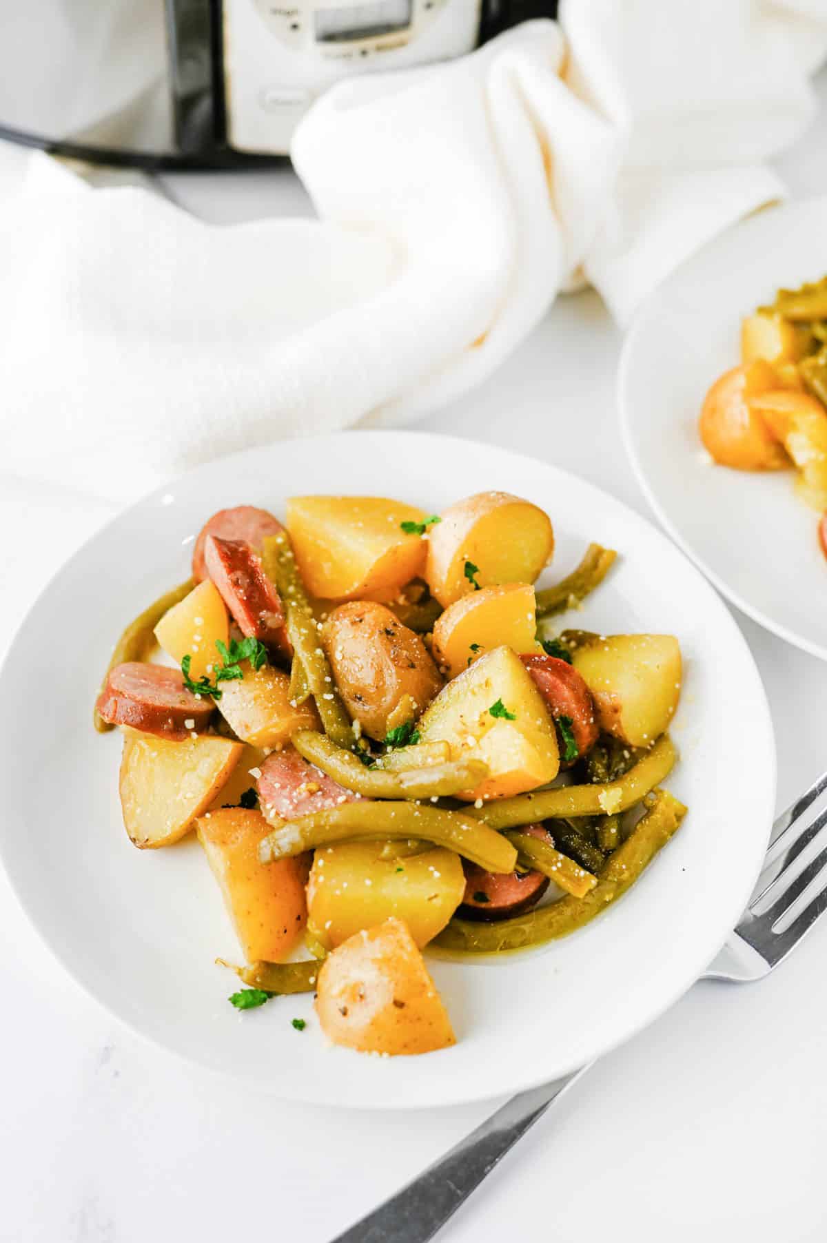 Looking for an easy slow cooker dinner the whole family will love? These Crock Pot Swamp Potatoes are loaded with tender baby potatoes, smoky sausage, green beans, buttery ranch flavor, and a kick of Cajun seasoning for a hearty meal that's packed with comfort. Everything cooks together in the crock pot, making this one of the easiest dump-and-go recipes for busy weeknights, lazy weekends, or cozy family dinners. If you love simple slow cooker recipes, sausage and potatoes, one pot meals, Southern-inspired comfort food, and budget-friendly dinners, this recipe deserves a spot on your menu. Serve it with crusty bread or enjoy it as a complete meal that's filling, flavorful, and guaranteed to have everyone coming back for seconds.