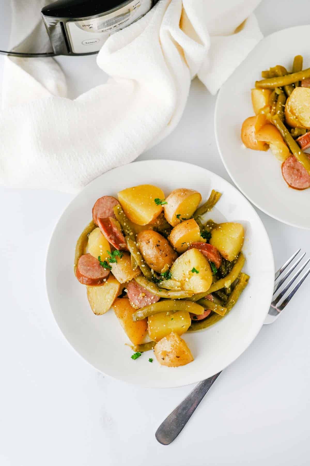 Looking for an easy slow cooker dinner the whole family will love? These Crock Pot Swamp Potatoes are loaded with tender baby potatoes, smoky sausage, green beans, buttery ranch flavor, and a kick of Cajun seasoning for a hearty meal that's packed with comfort. Everything cooks together in the crock pot, making this one of the easiest dump-and-go recipes for busy weeknights, lazy weekends, or cozy family dinners. If you love simple slow cooker recipes, sausage and potatoes, one pot meals, Southern-inspired comfort food, and budget-friendly dinners, this recipe deserves a spot on your menu. Serve it with crusty bread or enjoy it as a complete meal that's filling, flavorful, and guaranteed to have everyone coming back for seconds.
