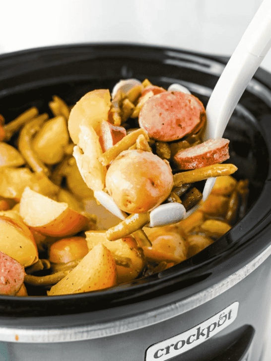 Looking for an easy slow cooker dinner the whole family will love? These Crock Pot Swamp Potatoes are loaded with tender baby potatoes, smoky sausage, green beans, buttery ranch flavor, and a kick of Cajun seasoning for a hearty meal that's packed with comfort. Everything cooks together in the crock pot, making this one of the easiest dump-and-go recipes for busy weeknights, lazy weekends, or cozy family dinners. If you love simple slow cooker recipes, sausage and potatoes, one pot meals, Southern-inspired comfort food, and budget-friendly dinners, this recipe deserves a spot on your menu. Serve it with crusty bread or enjoy it as a complete meal that's filling, flavorful, and guaranteed to have everyone coming back for seconds.
