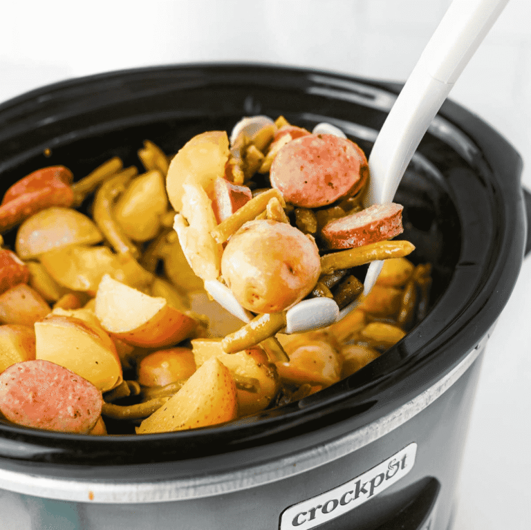 Looking for an easy slow cooker dinner the whole family will love? These Crock Pot Swamp Potatoes are loaded with tender baby potatoes, smoky sausage, green beans, buttery ranch flavor, and a kick of Cajun seasoning for a hearty meal that's packed with comfort. Everything cooks together in the crock pot, making this one of the easiest dump-and-go recipes for busy weeknights, lazy weekends, or cozy family dinners. If you love simple slow cooker recipes, sausage and potatoes, one pot meals, Southern-inspired comfort food, and budget-friendly dinners, this recipe deserves a spot on your menu. Serve it with crusty bread or enjoy it as a complete meal that's filling, flavorful, and guaranteed to have everyone coming back for seconds.
