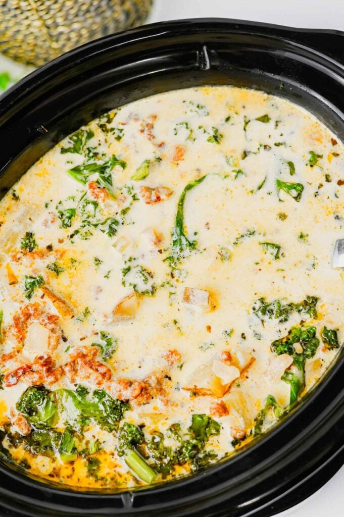 This Crockpot Zuppa Toscana is the ultimate comfort soup recipe loaded with Italian sausage, potatoes, bacon, kale and a rich creamy broth. If you love Copycat Olive Garden Zuppa Toscana, this Slow Cooker Zuppa Toscana is an easy family dinner that tastes even better than the restaurant version. Learn How To Make Olive Garden Zuppa Toscana at home with simple ingredients and minimal prep. This Zuppa Toscana Soup Recipe is perfect for busy weeknights, cozy weekends and feeding a crowd. Whether you're searching for Easy Soup Recipes, Italian Soup Recipes, Sausage And Kale Soup, Kale Soup Recipes, Homemade Soup Recipe ideas or a delicious Crockpot Zuppa Toscana, this hearty Toscana Soup delivers big flavor in every bite. Save this Easy Zuppa Toscana Soup for your next Soup Dinner night!