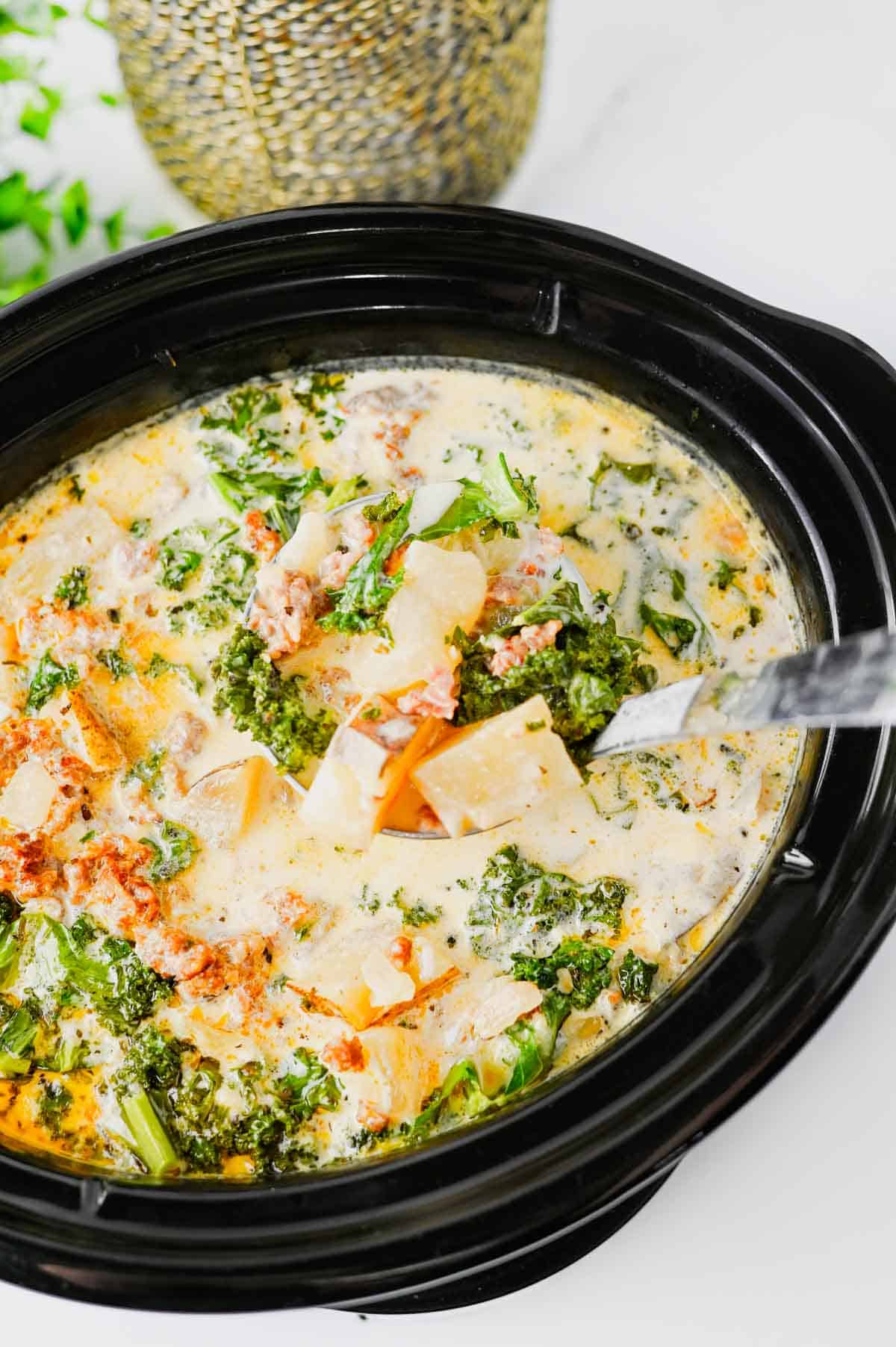 This Crockpot Zuppa Toscana is the ultimate comfort soup recipe loaded with Italian sausage, potatoes, bacon, kale and a rich creamy broth. If you love Copycat Olive Garden Zuppa Toscana, this Slow Cooker Zuppa Toscana is an easy family dinner that tastes even better than the restaurant version. Learn How To Make Olive Garden Zuppa Toscana at home with simple ingredients and minimal prep. This Zuppa Toscana Soup Recipe is perfect for busy weeknights, cozy weekends and feeding a crowd. Whether you're searching for Easy Soup Recipes, Italian Soup Recipes, Sausage And Kale Soup, Kale Soup Recipes, Homemade Soup Recipe ideas or a delicious Crockpot Zuppa Toscana, this hearty Toscana Soup delivers big flavor in every bite. Save this Easy Zuppa Toscana Soup for your next Soup Dinner night!