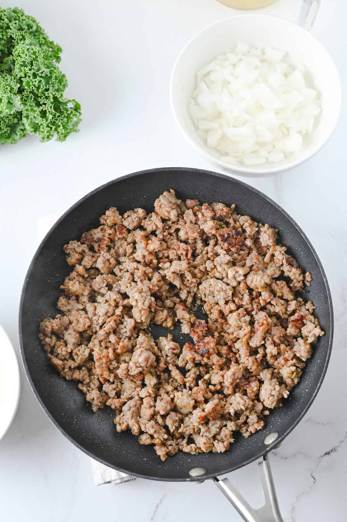 cooked and crumbled sausage in skillet