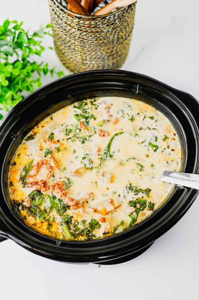 This Crockpot Zuppa Toscana is the ultimate comfort soup recipe loaded with Italian sausage, potatoes, bacon, kale and a rich creamy broth. If you love Copycat Olive Garden Zuppa Toscana, this Slow Cooker Zuppa Toscana is an easy family dinner that tastes even better than the restaurant version. Learn How To Make Olive Garden Zuppa Toscana at home with simple ingredients and minimal prep. This Zuppa Toscana Soup Recipe is perfect for busy weeknights, cozy weekends and feeding a crowd. Whether you're searching for Easy Soup Recipes, Italian Soup Recipes, Sausage And Kale Soup, Kale Soup Recipes, Homemade Soup Recipe ideas or a delicious Crockpot Zuppa Toscana, this hearty Toscana Soup delivers big flavor in every bite. Save this Easy Zuppa Toscana Soup for your next Soup Dinner night!