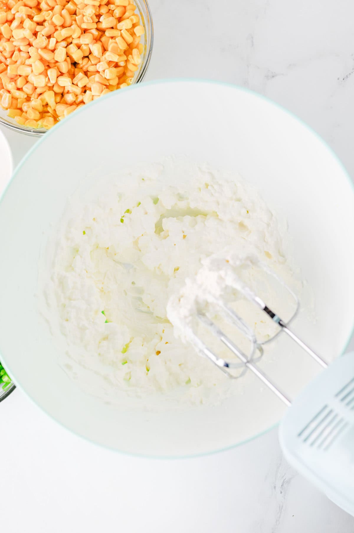 cream cheese and sour cream blended together in a mixing bowl