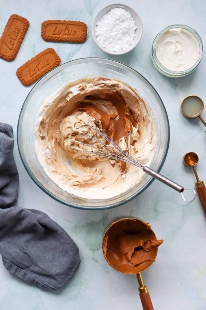 Biscoff spread added to bowl with cream cheese mixture