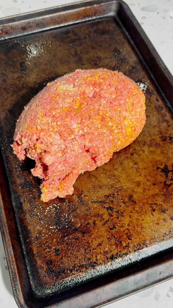 raw ground beef on baking sheet