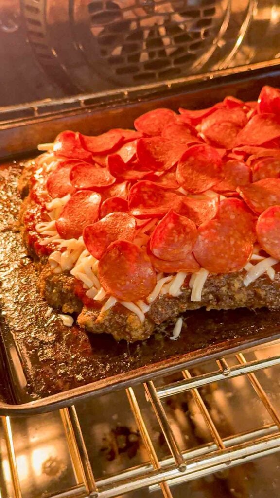 pepperoni topped meatloaf baking in the oven