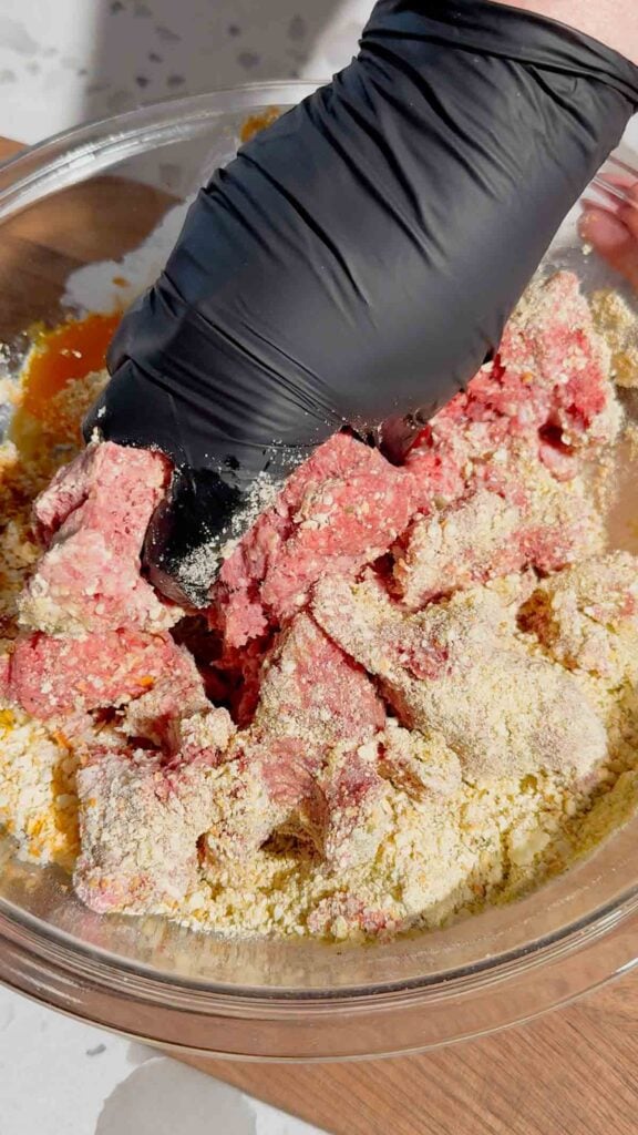mixing meatloaf mixture in a mixing bowl